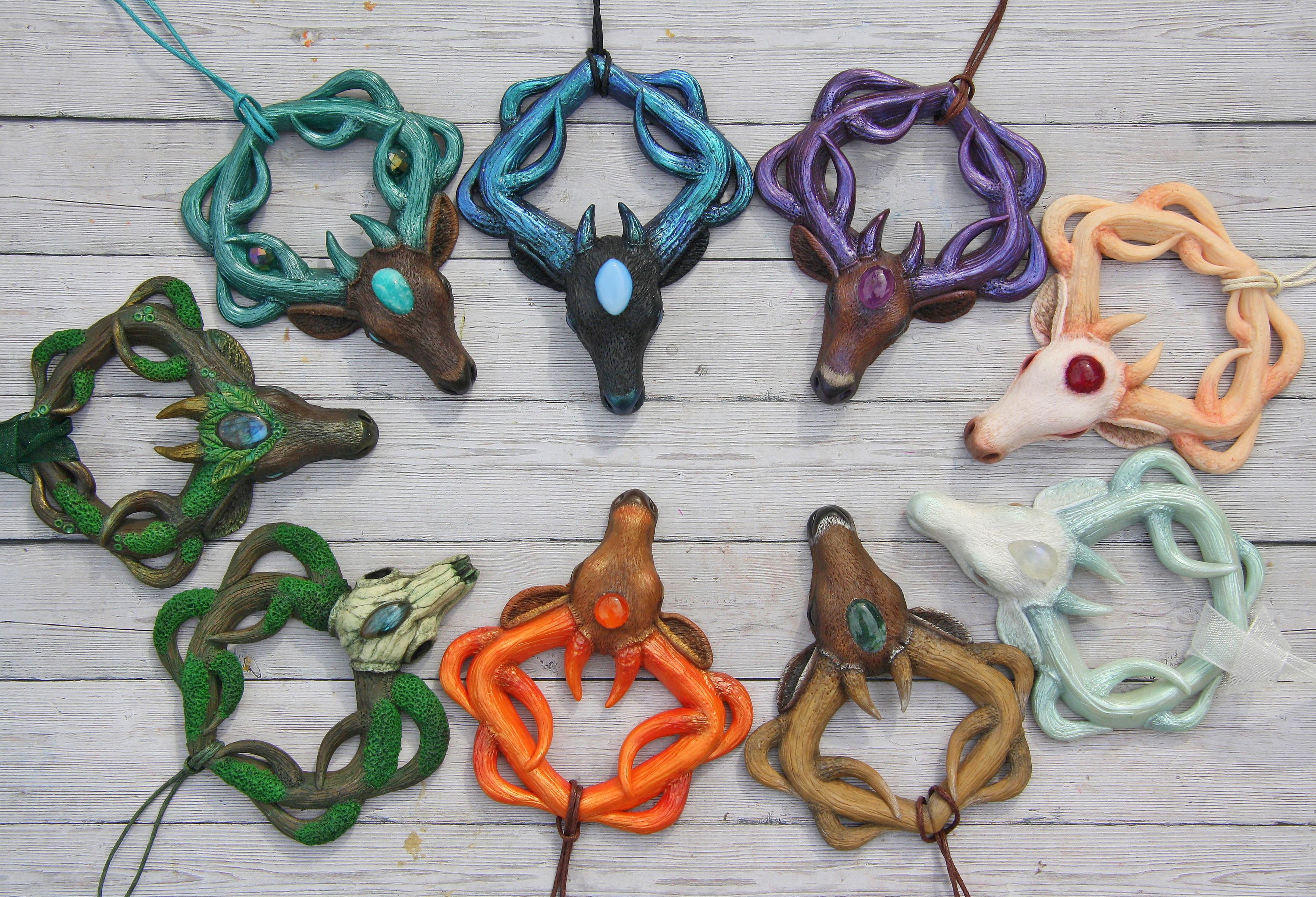 My polymer clay deer pendants, each decorated with crystals, available