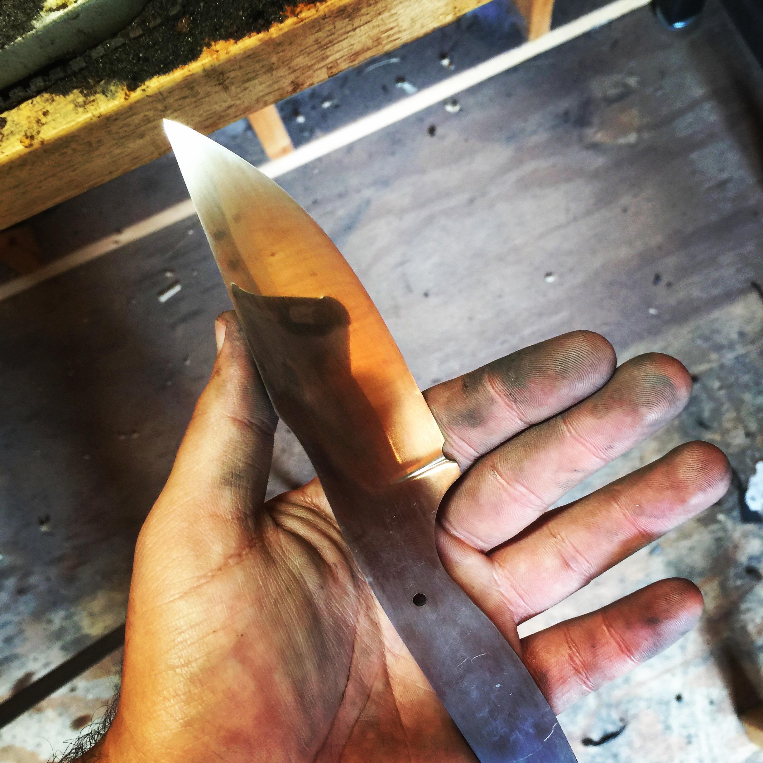 Working On My First MirrorFinished Knife (you can see the reflection of my phone on the blade
