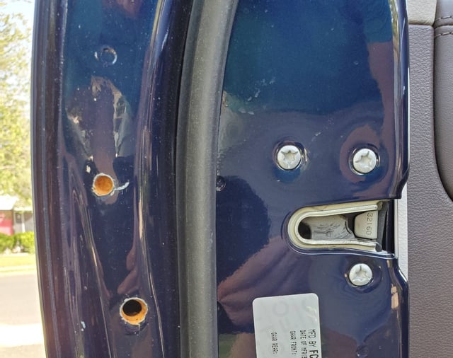 chrysler Holes drilled in driver side Door Jamb? Motor Vehicle