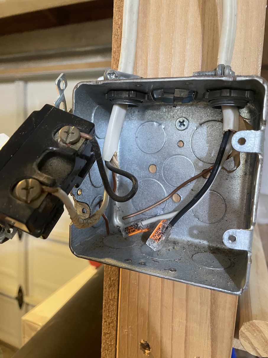 Why did a wire short to the metal junction box without tripping the