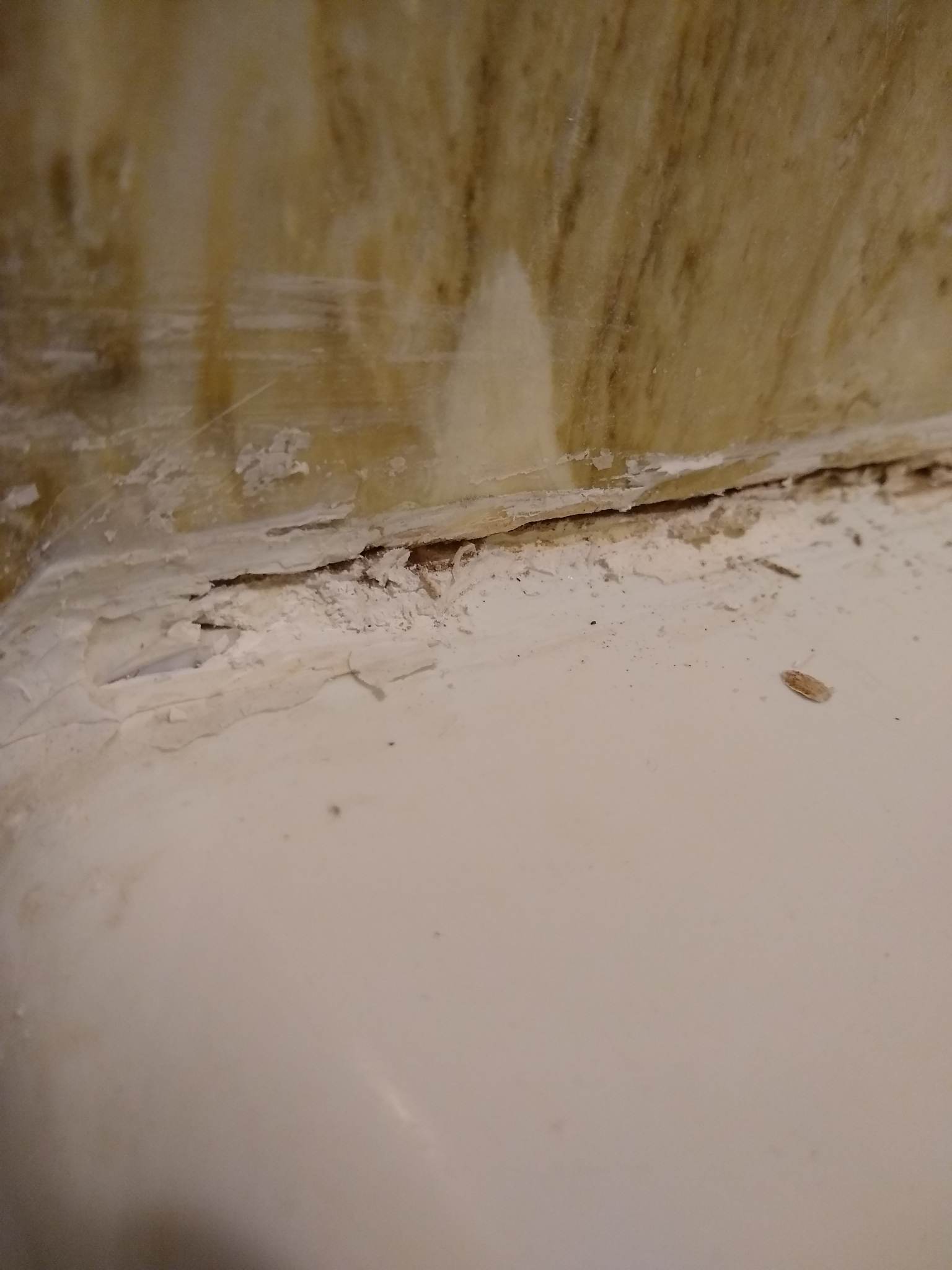 How to remove plaster or really old hard caulk (can't tell) from bathtub? Home Improvement