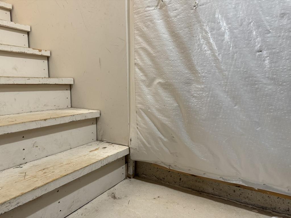 Framing basement wall against blanket wrap insulation in tight corner