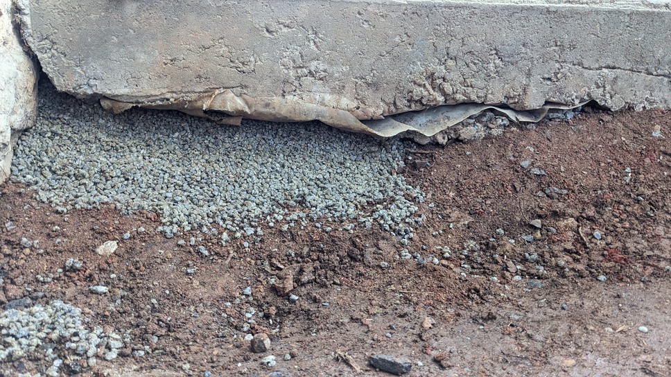 concrete Refilling gravel under slab on a downhill grade Home