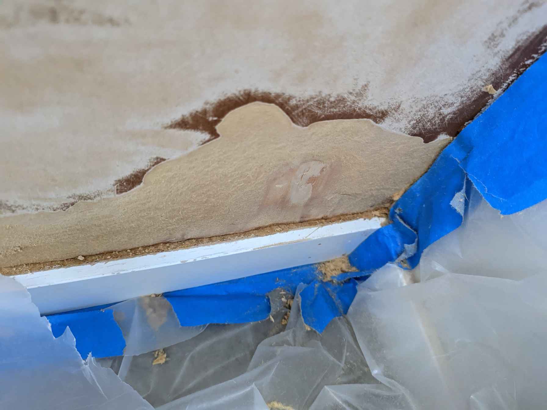 How to fix this water damage in what seems to be particle wood? Woodworking Stack Exchange