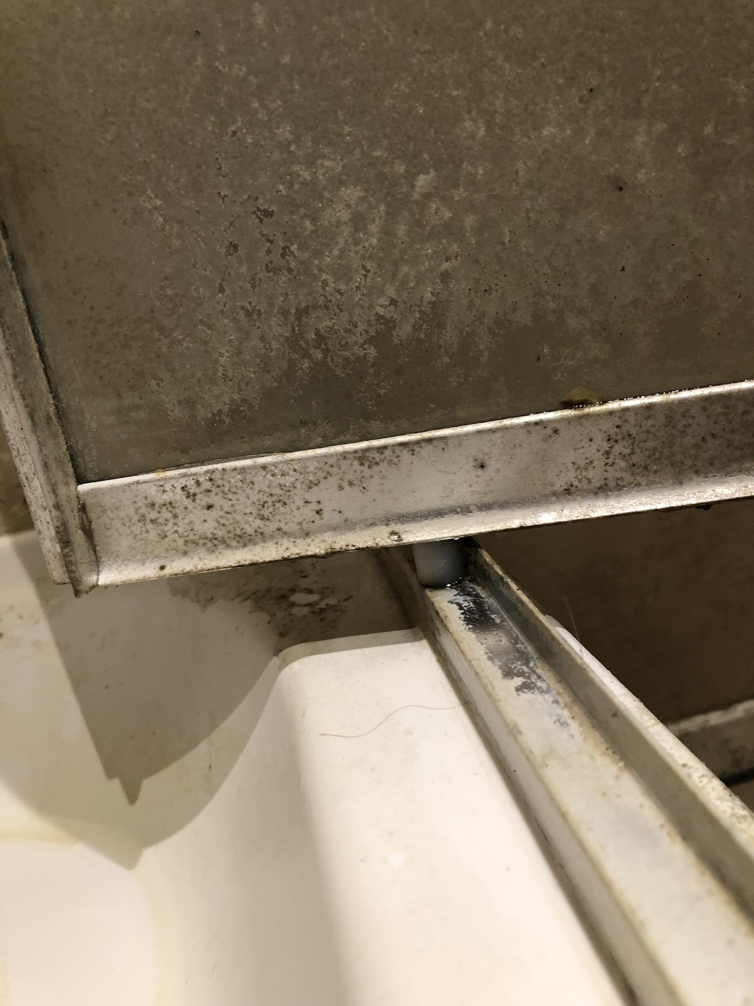 bathroom Sagging shower door with pivot point away from the wall