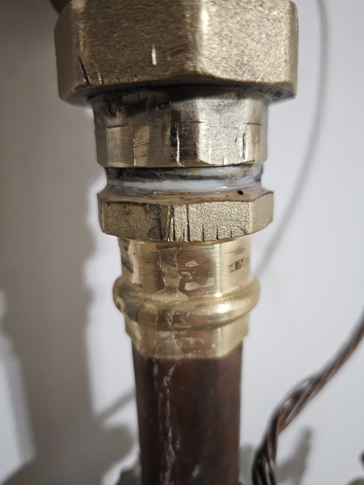 water How do I tighten this type of plumbing connection on a pressure regulator? Home