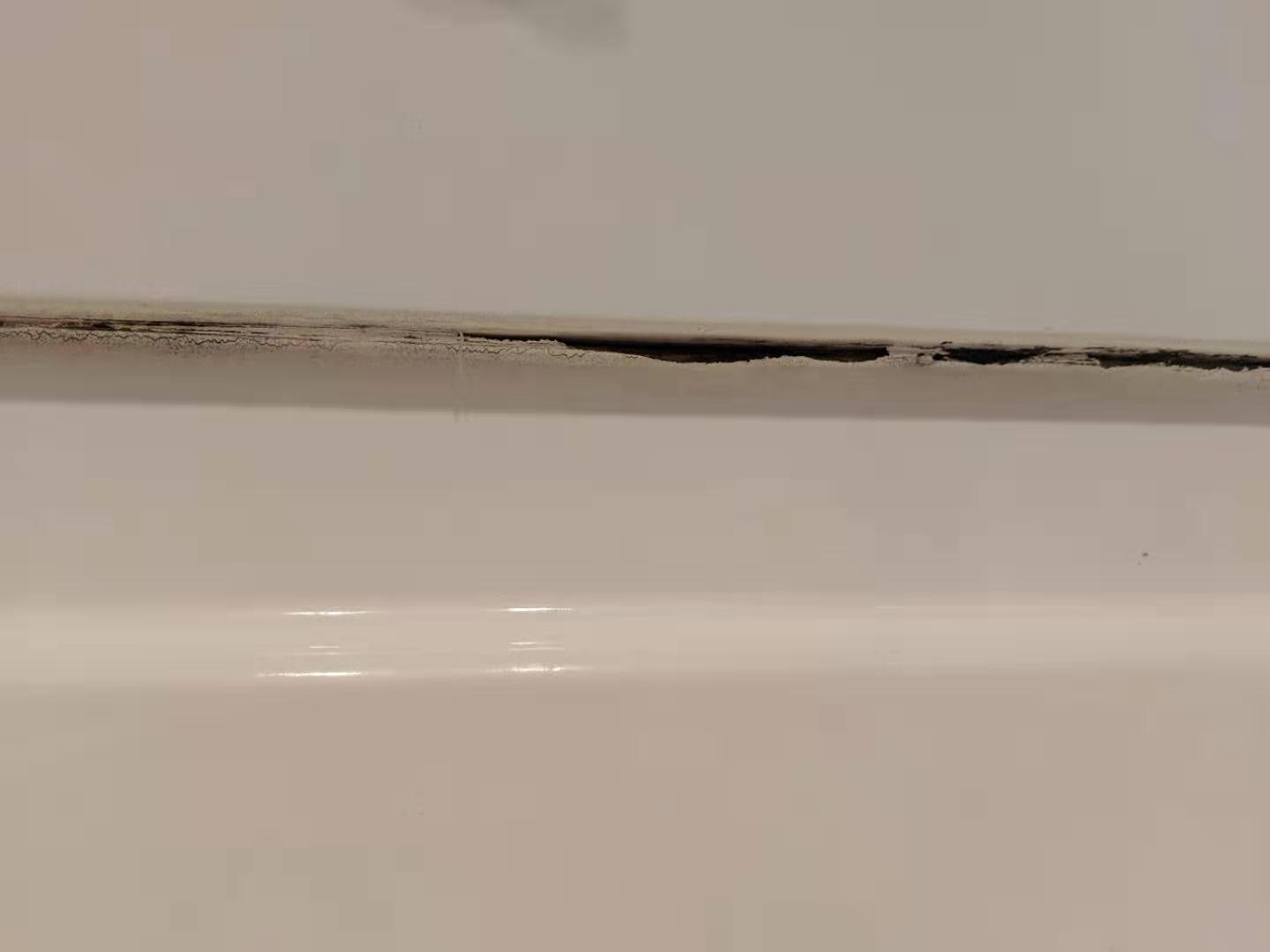 bathroom How can I fix cracks between the bathtub and the wall