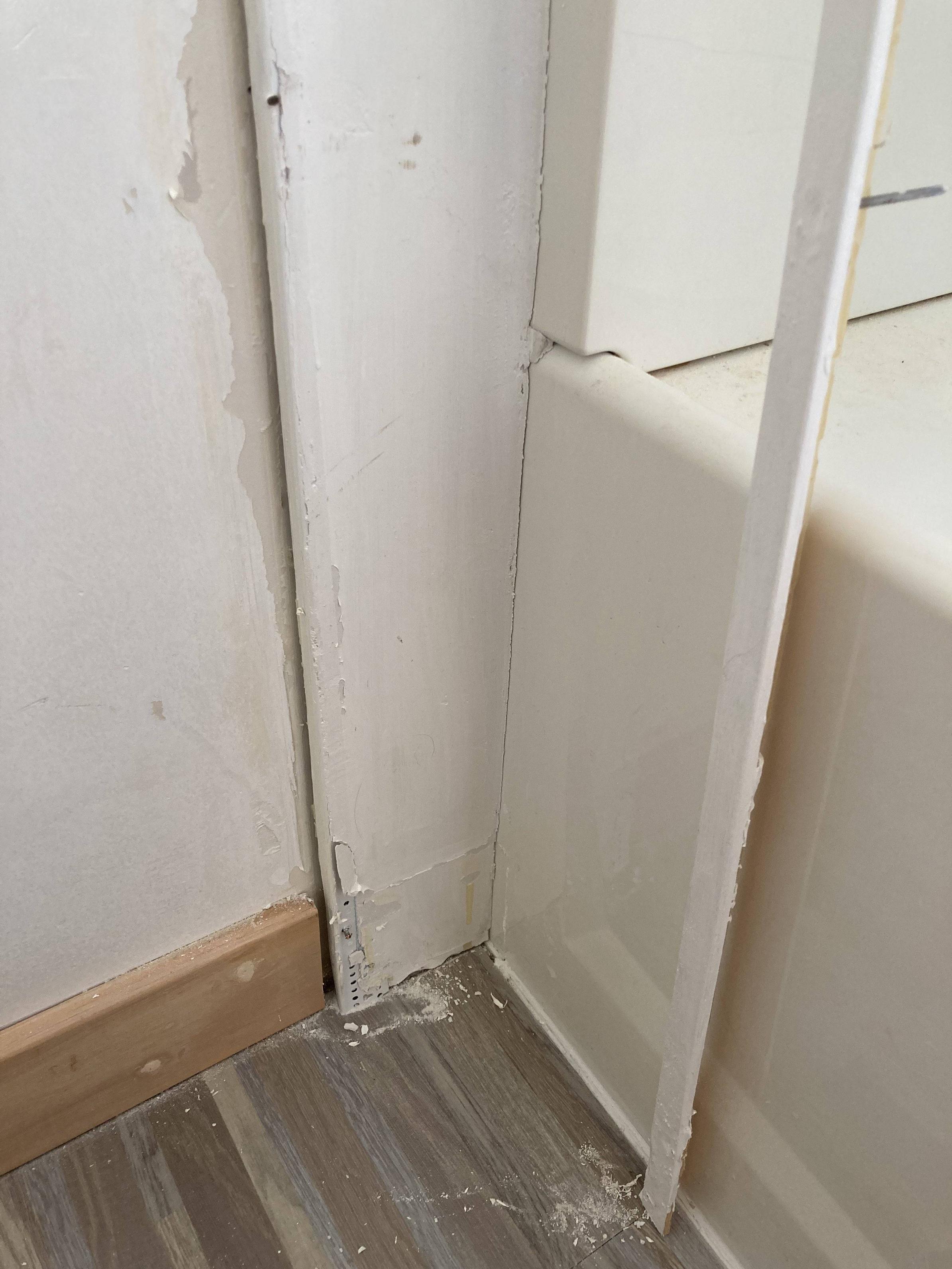 bathroom Metal transition strip between bathtub/shower and wall