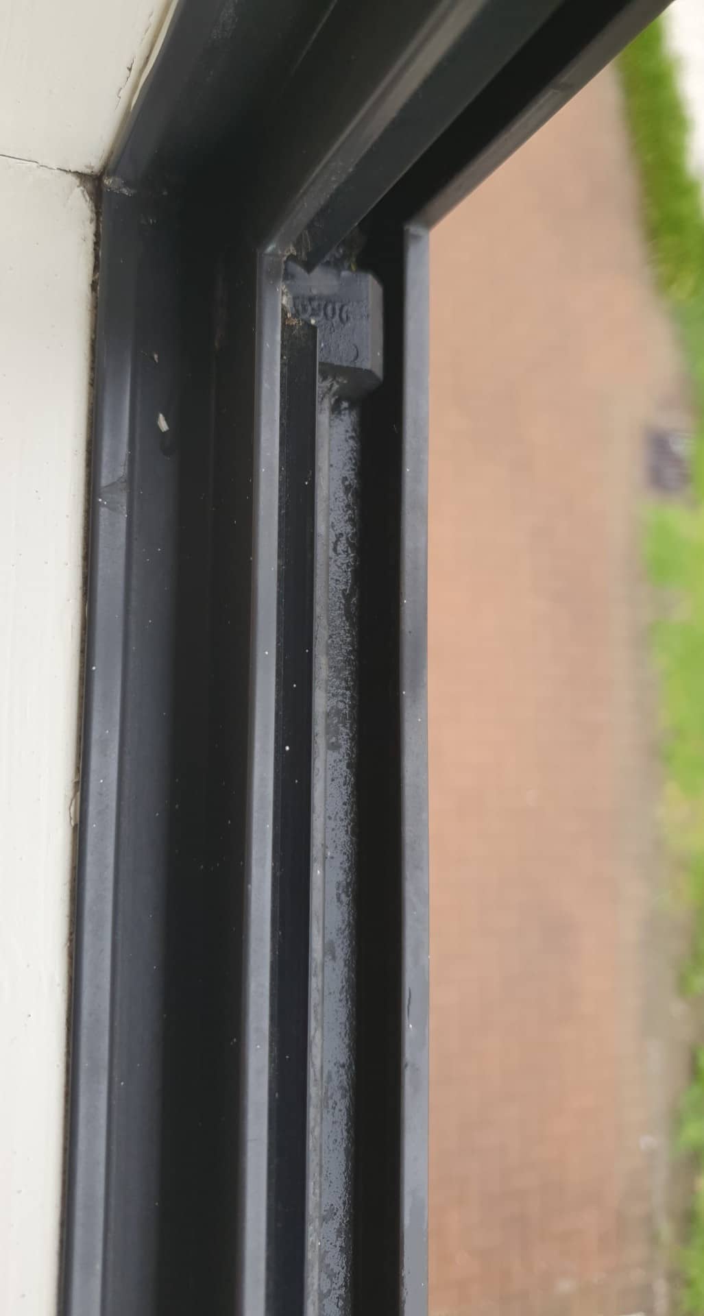 Water leaks through the base of the window through a hole during hard