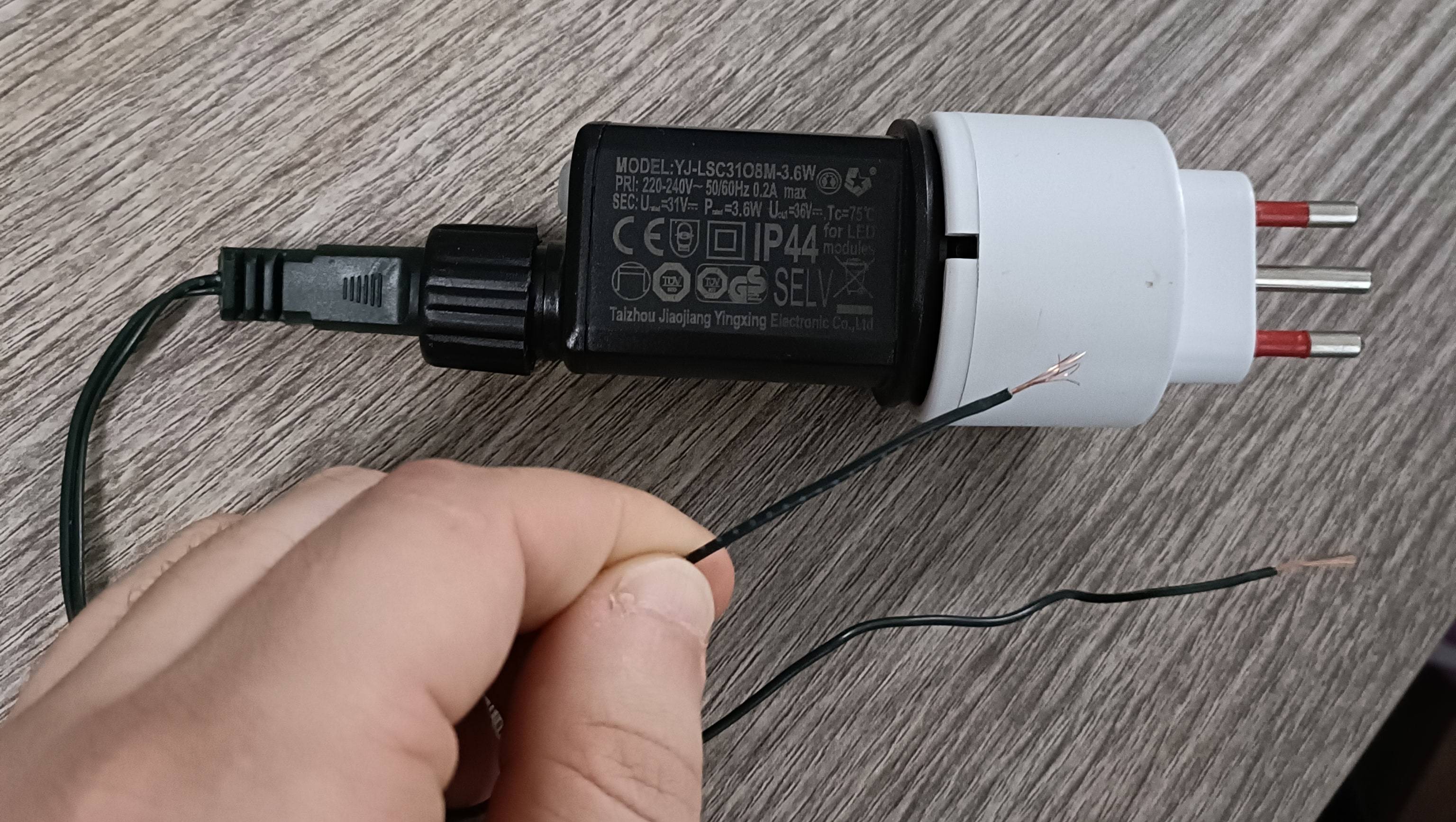 voltmeter Reading voltage across Christmas light wires, multimeter