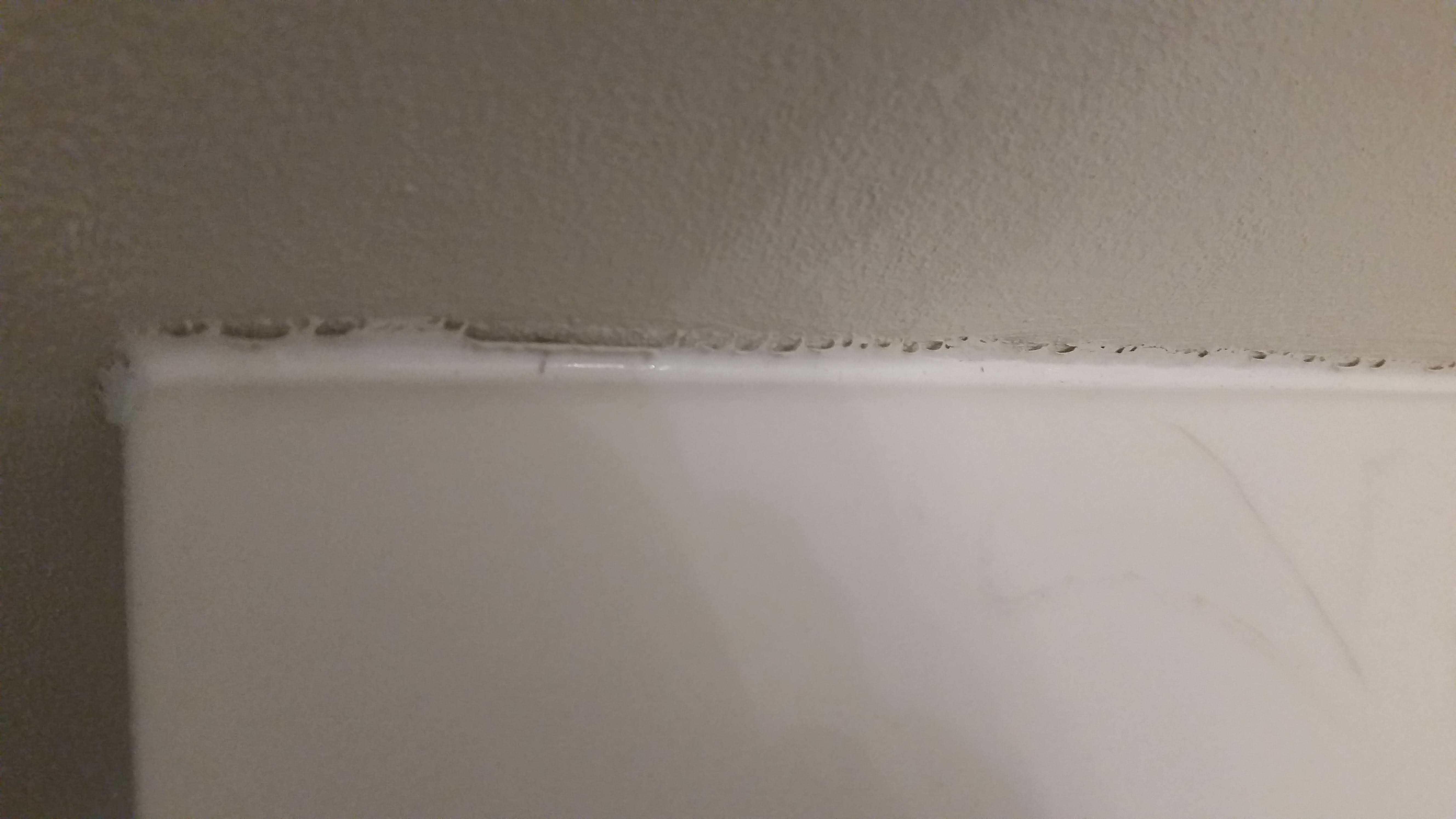 Why is silicone caulk “falling” or peeling away from new bath