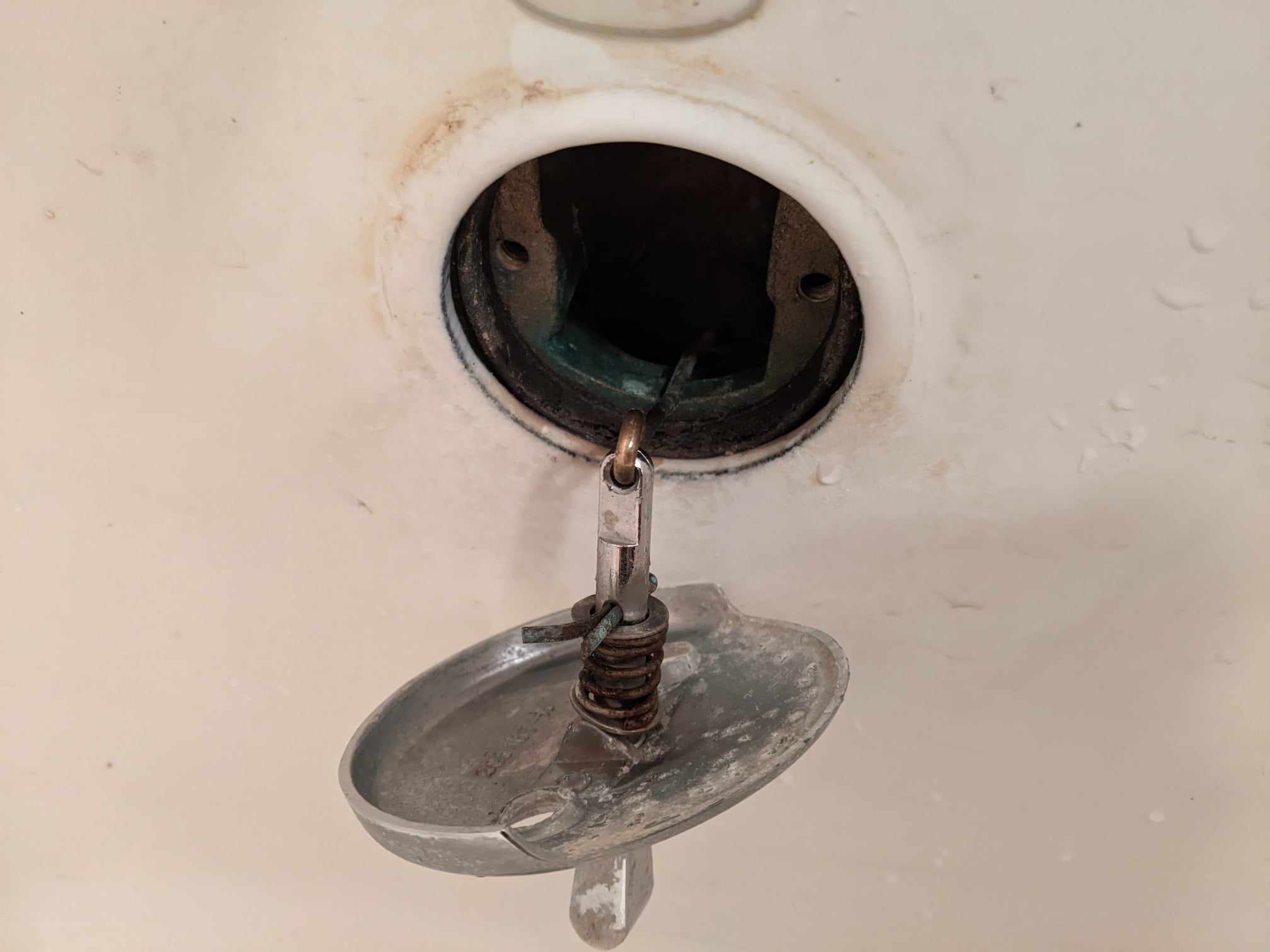 Bathtub plunger/stopper is attached to chain but won't budge. It is