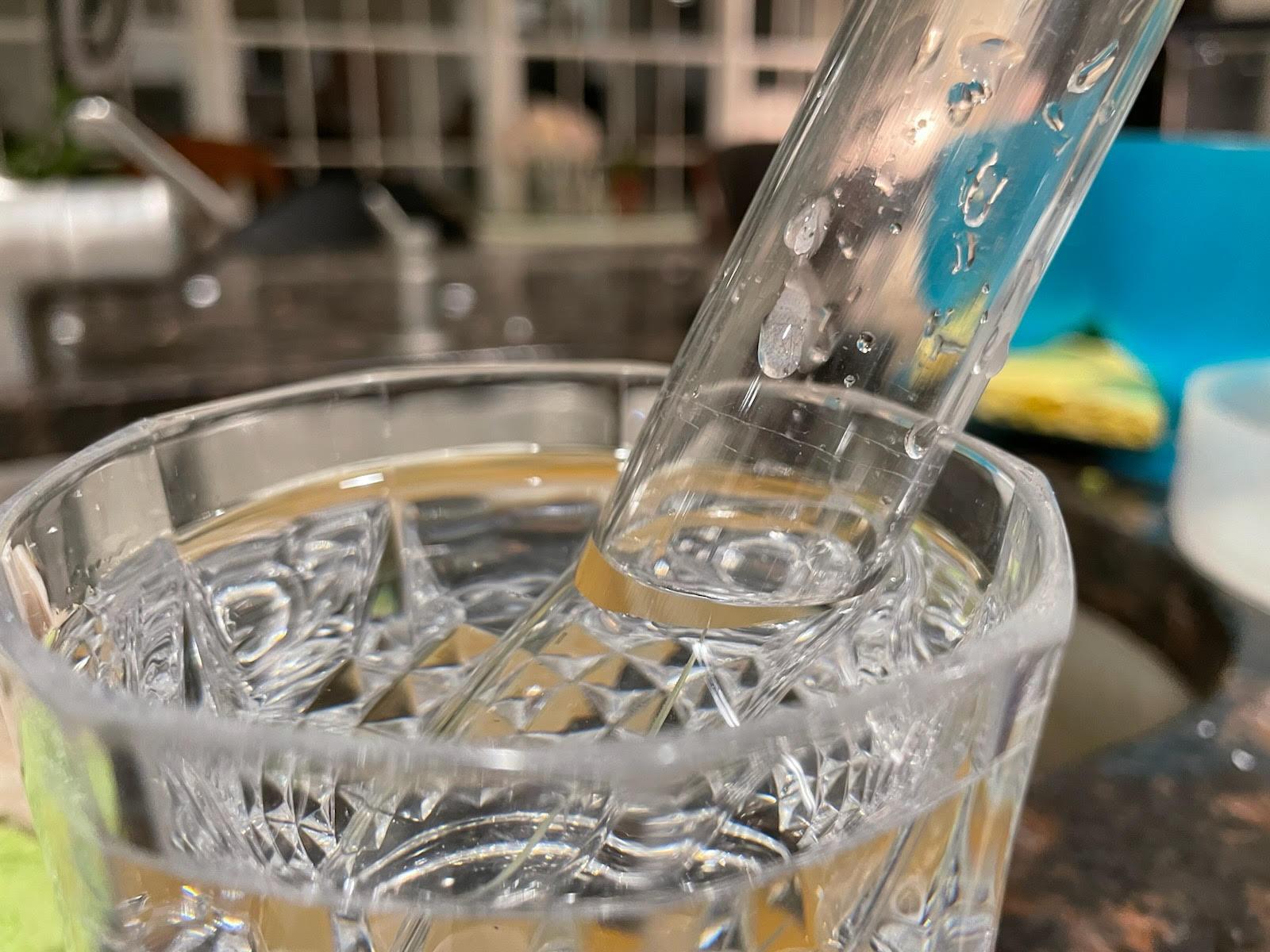 optics Why is the water level in the tube tilted instead of