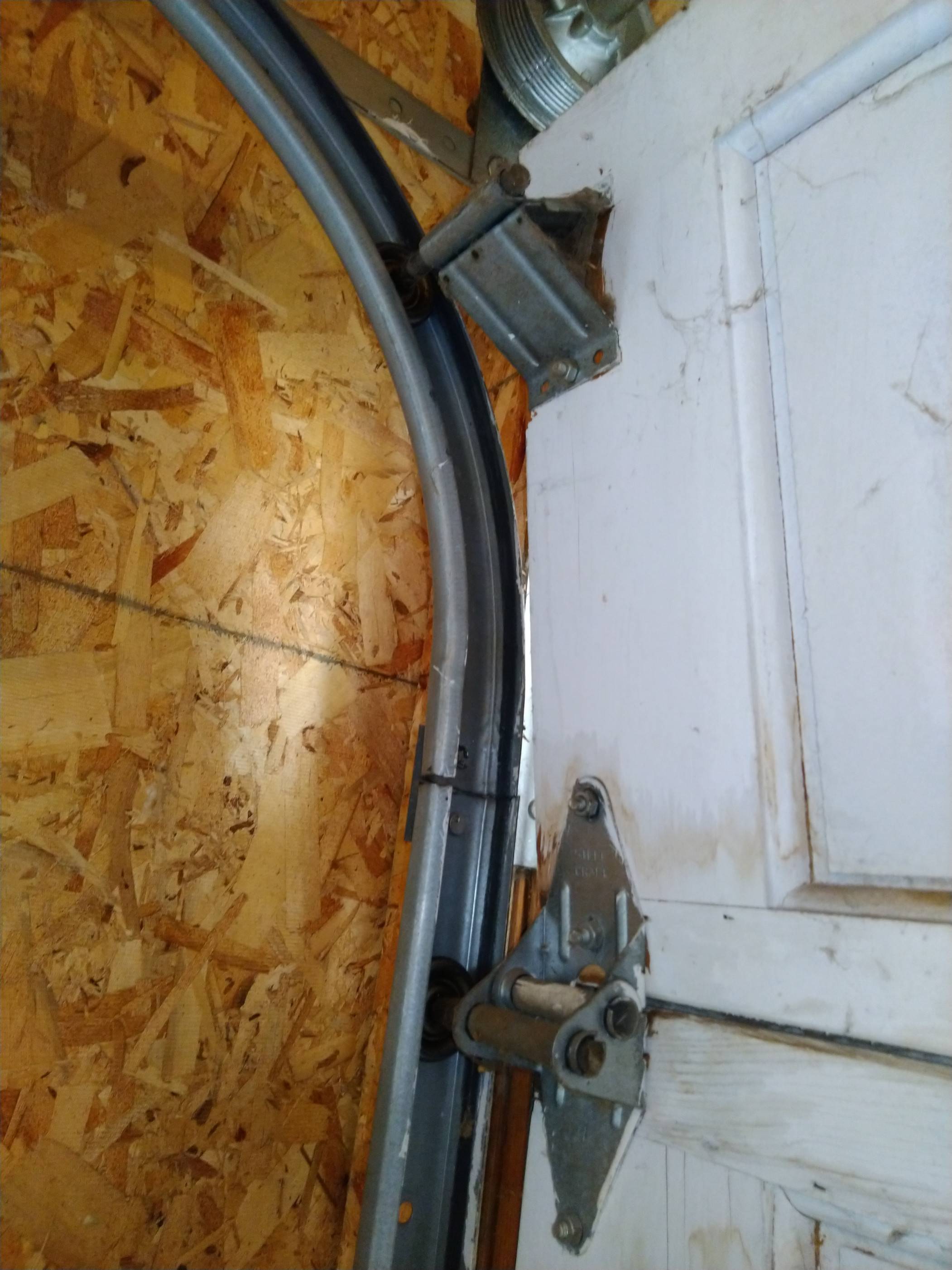 How can I fix my garage door to stop it from rubbing with the frame