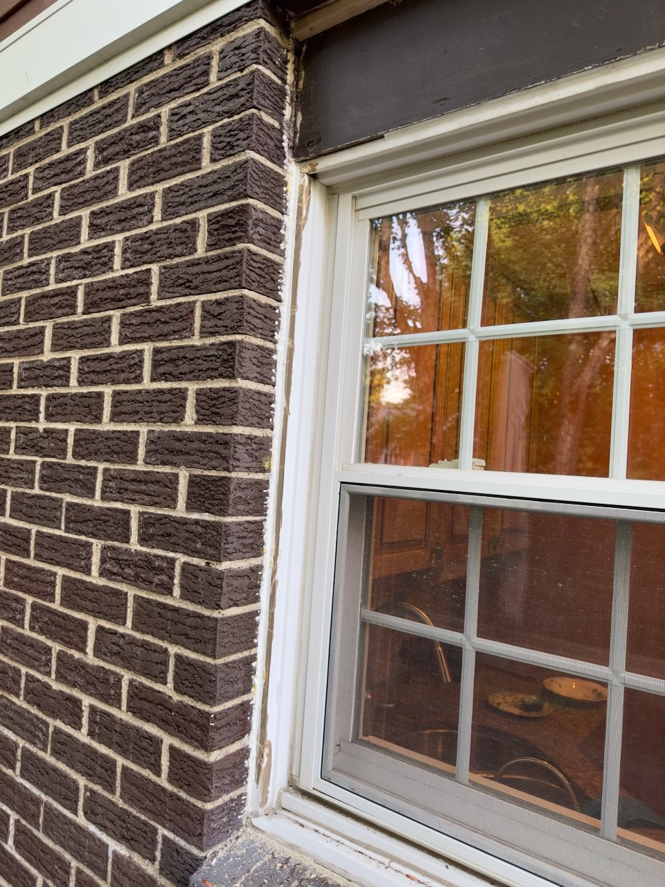 How do I seal and make this window in brick casement look better
