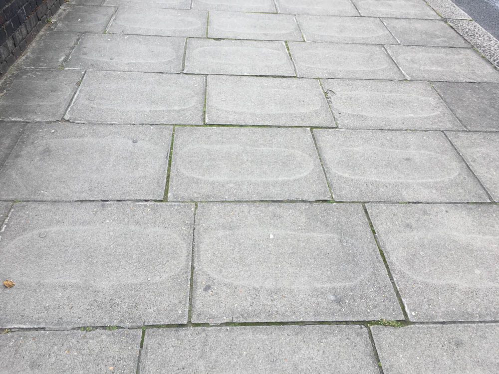 geometry Why did staining marks on these paving slabs form geometric