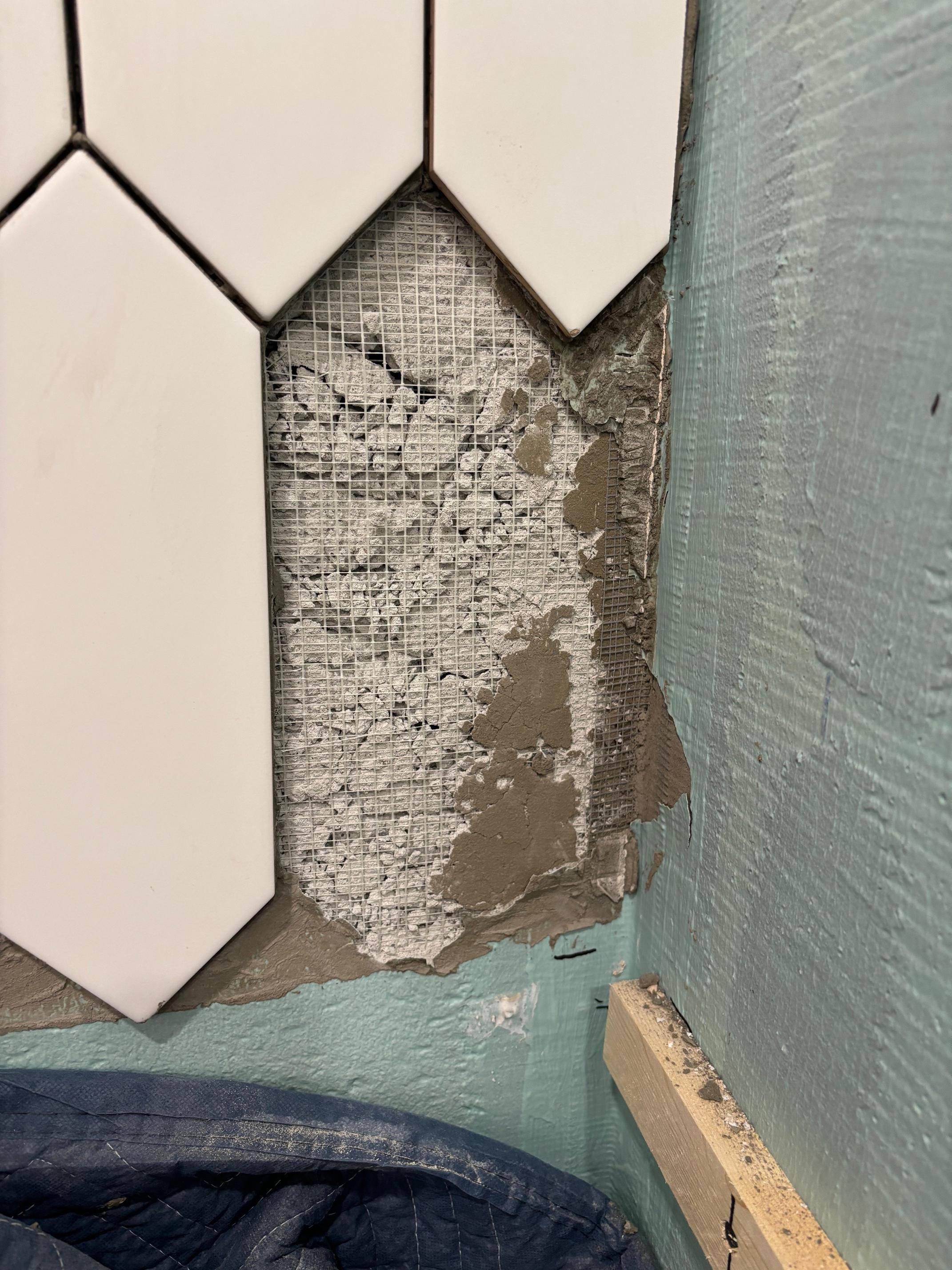 tiling Damaged cement board while removing a chipped tile. Can I