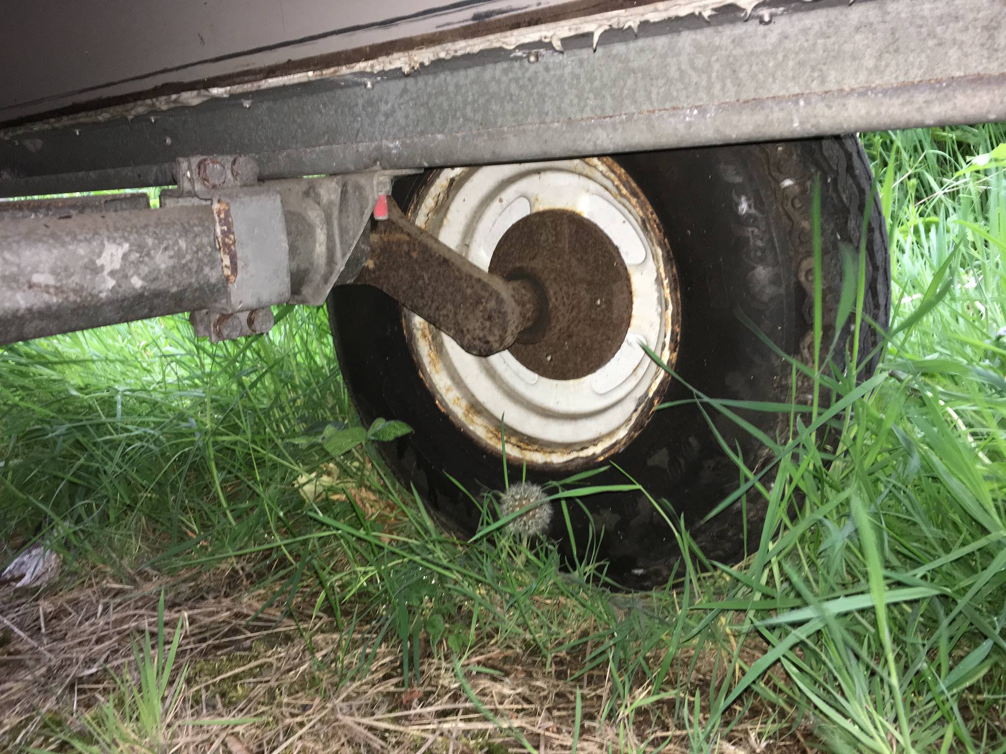 What to do about this rust on trailer wheel, suspension and part of