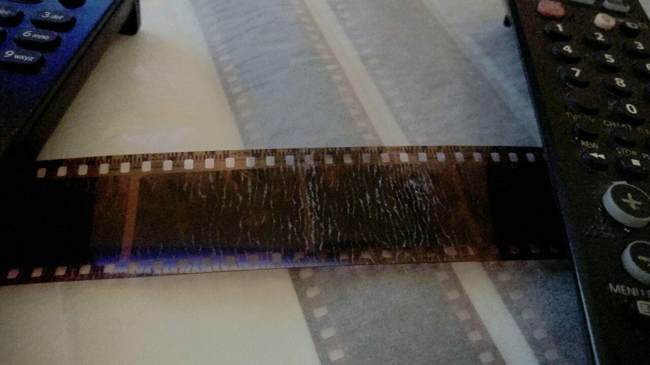 cleaning Clean film negatives heavily contaminated with wet paper made negative cases