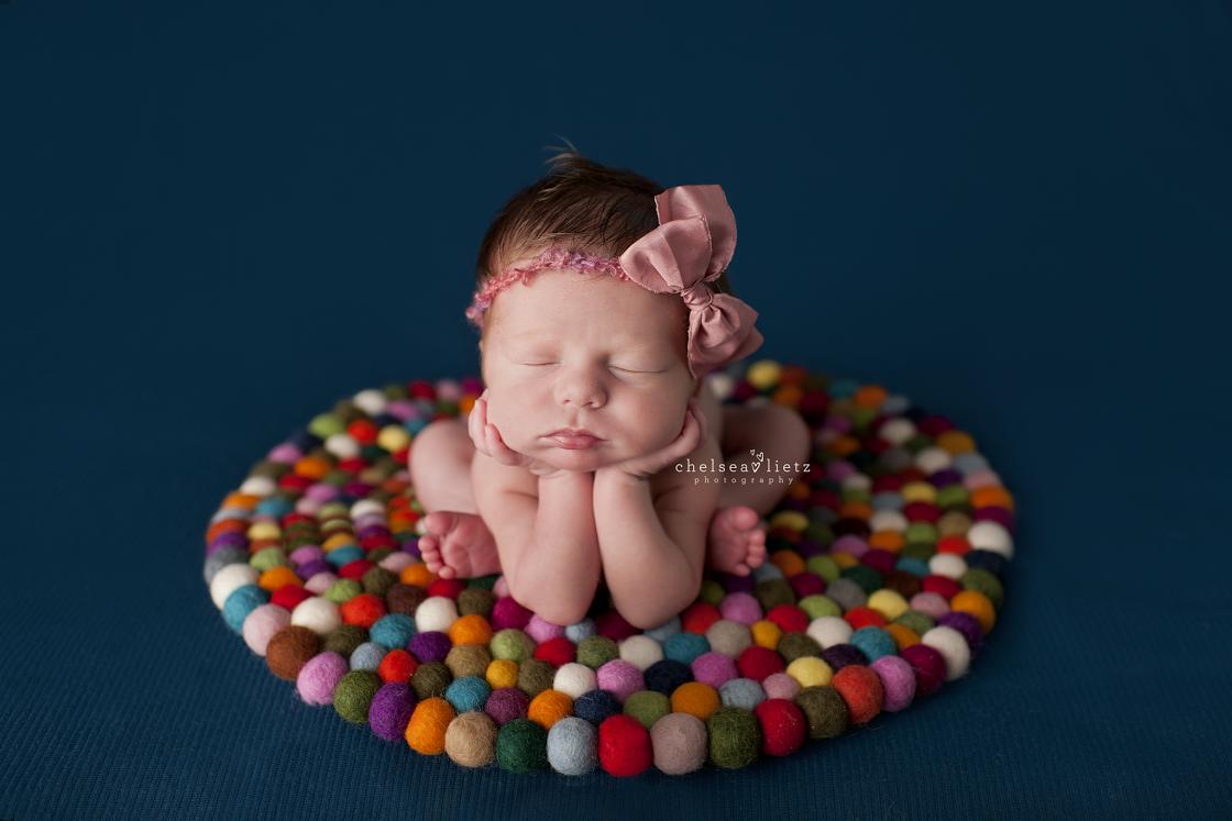 newborn How do you make an infant sleep on her stomach with her hands