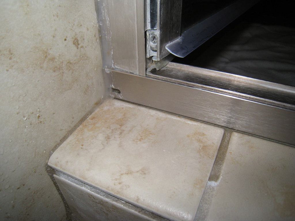 tile Water seeping out of grout in exterior corner of tiled shower