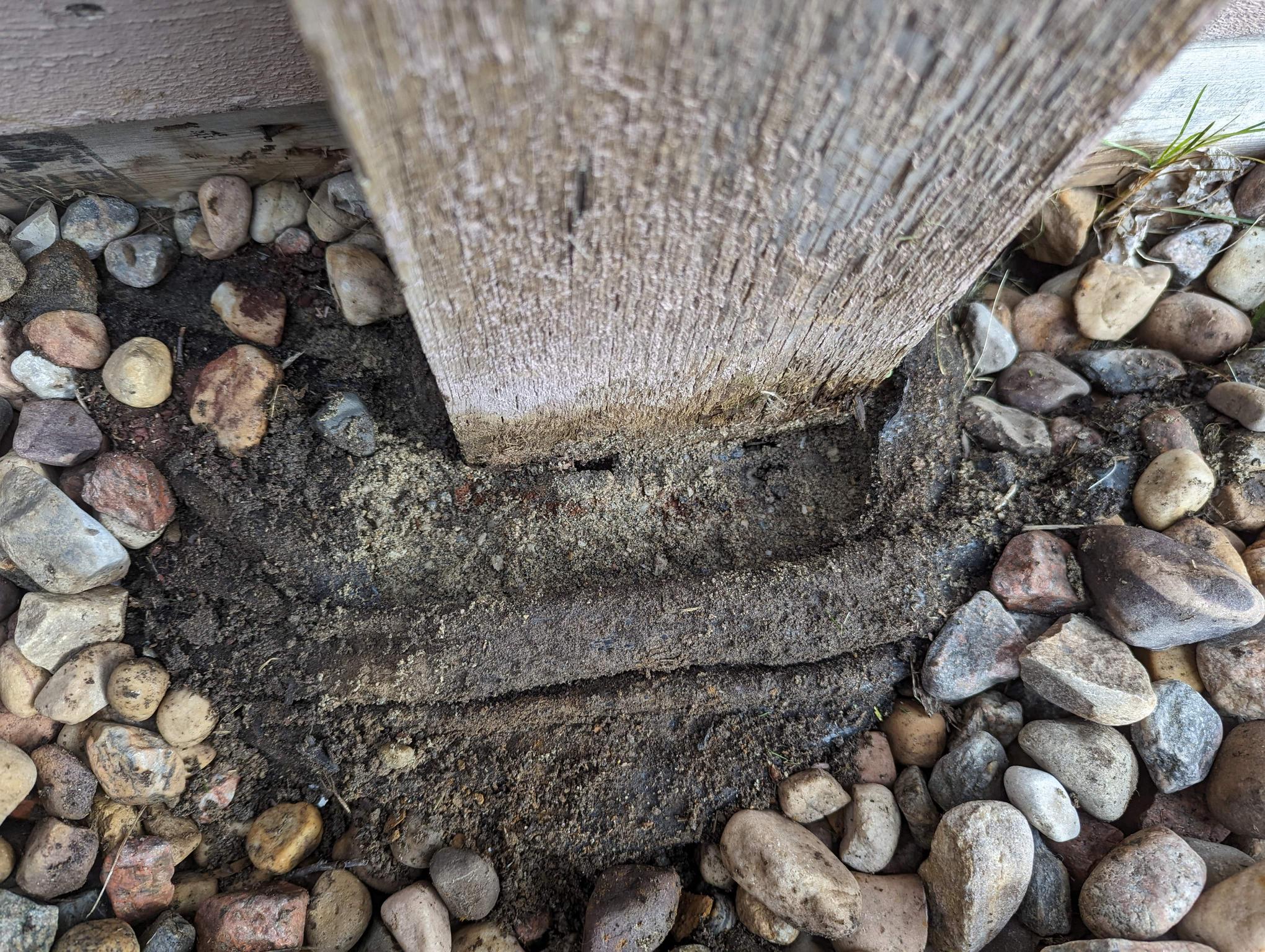 Can the concrete base of a fence post be reused for a new post, or does