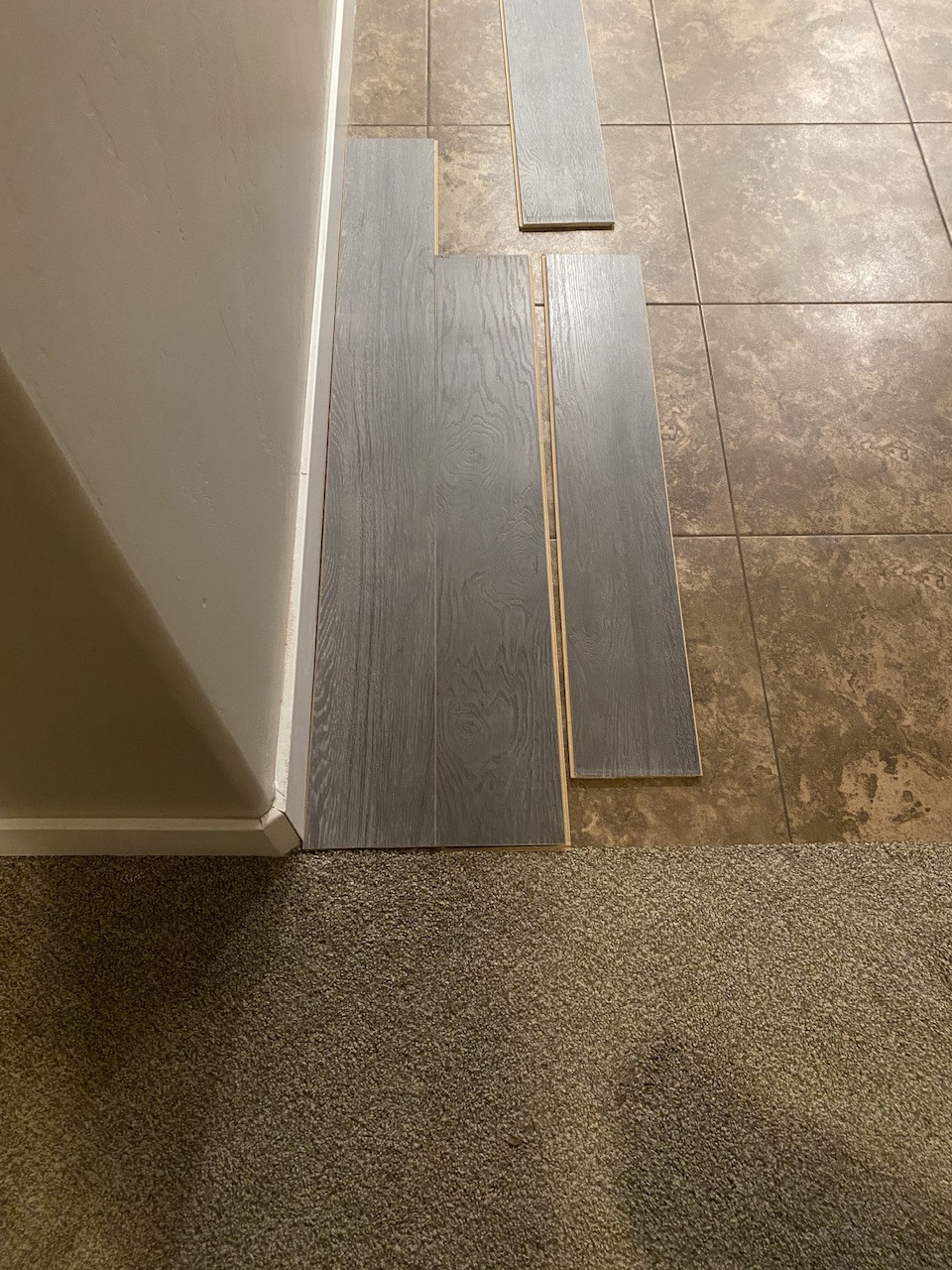 What is the best way to transition between plank flooring laid on top