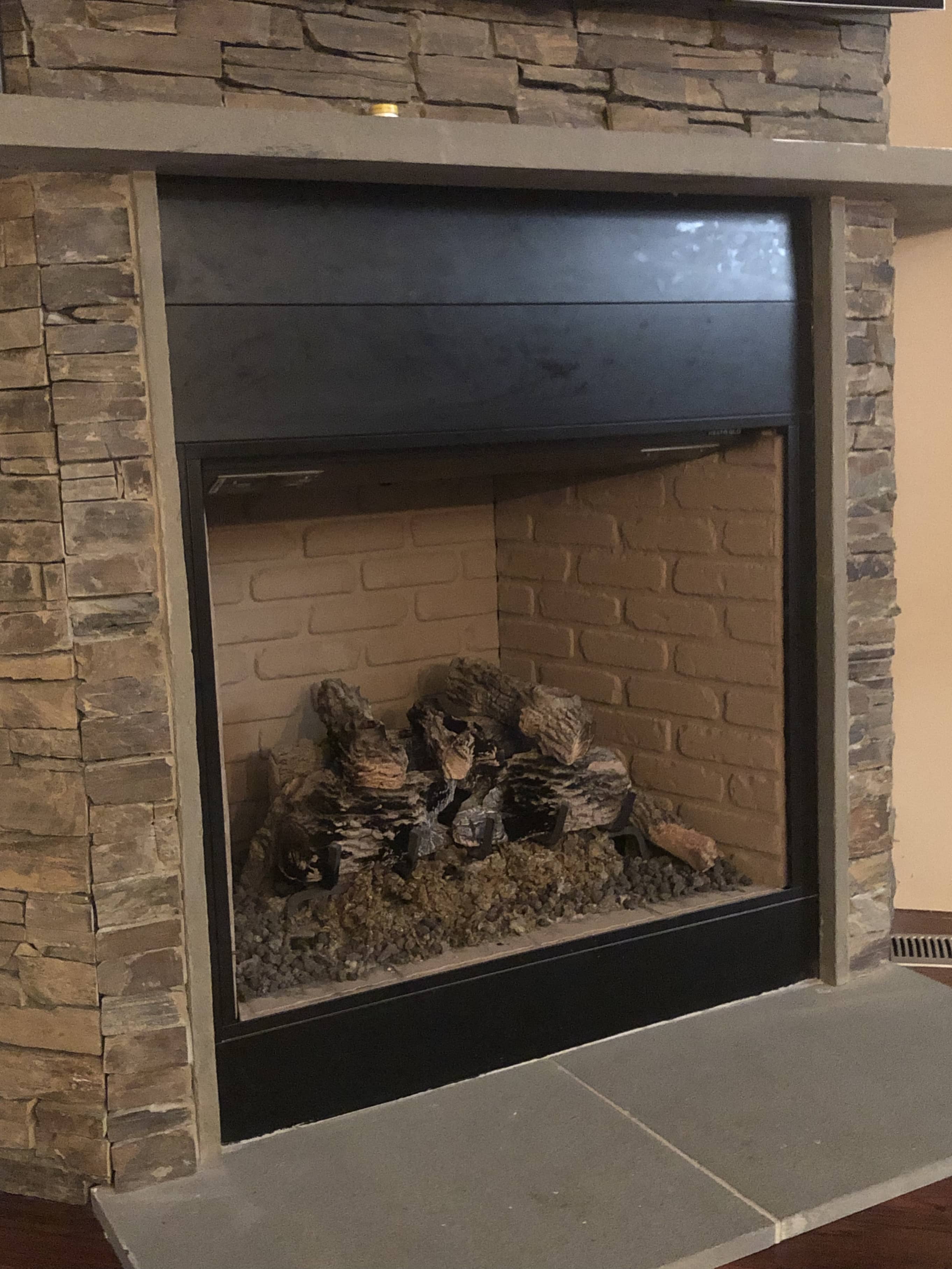 tile Placing stone over metal fireplace face. Is this possible