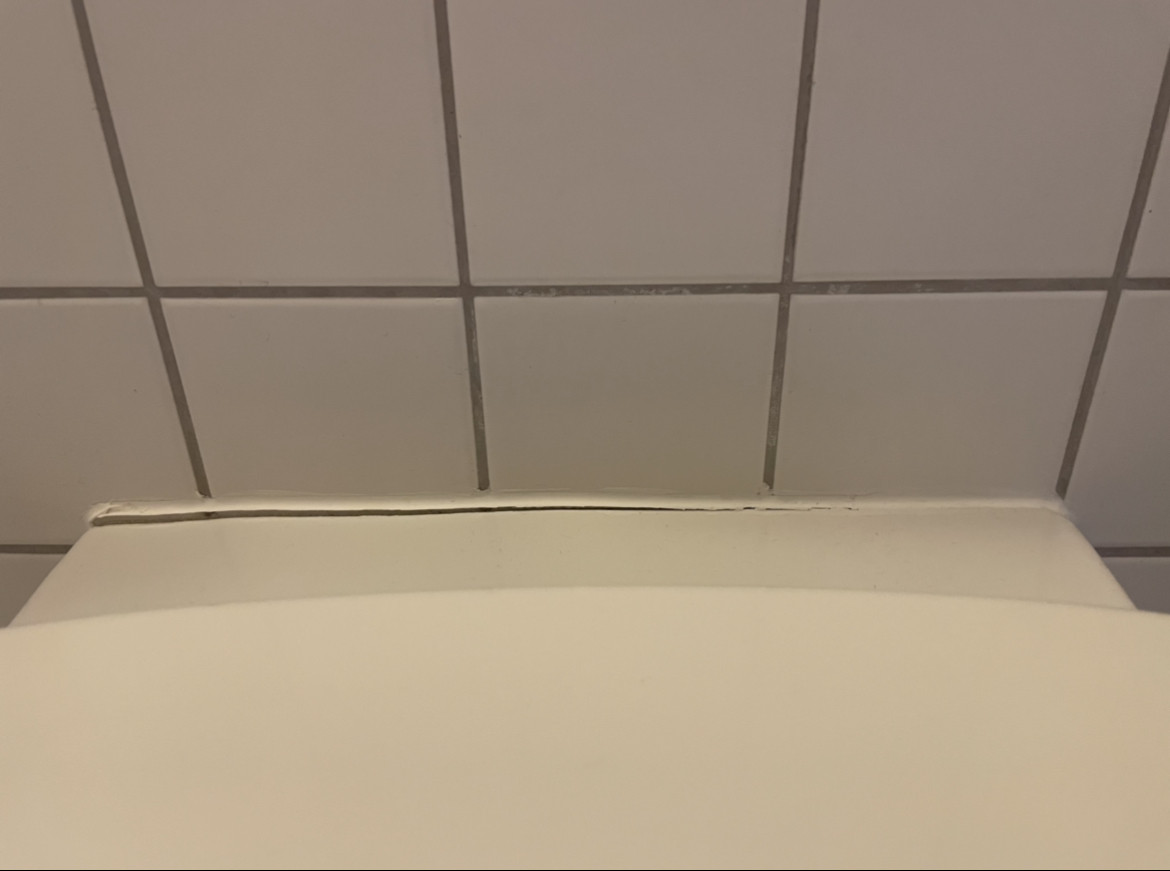 plumbing Gap between toilet and a "glue" on the wall Home