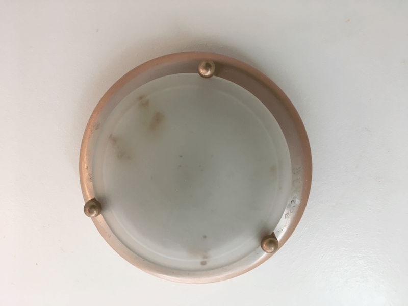 How to remove the glass and change bulb from this lighting fixture