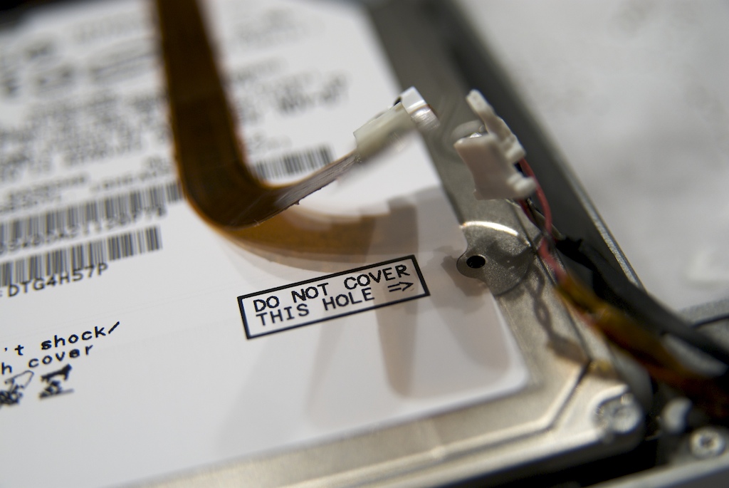 What is the purpose of the holes marked “Do Not Cover” on hard drives