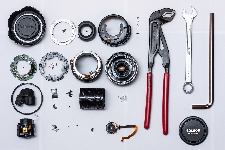 How do I disassemble my Canon 1855mm lens to repair water damage