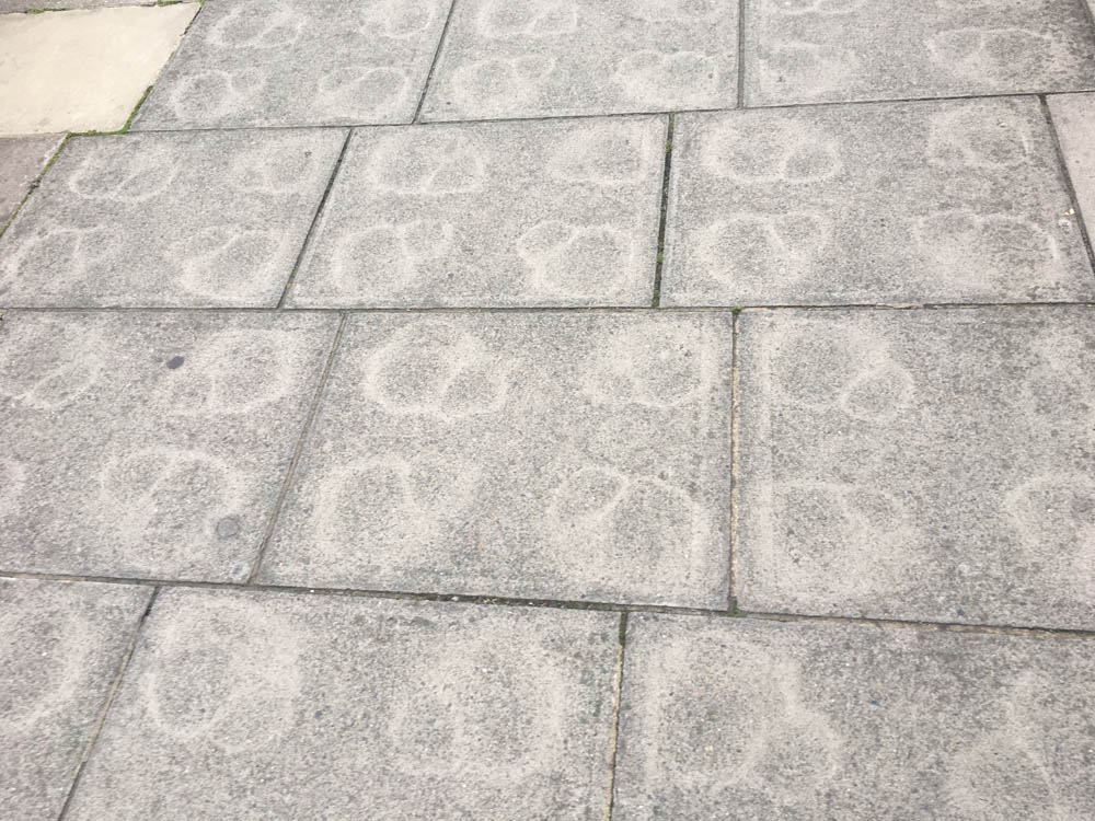 geometry Why did staining marks on these paving slabs form geometric