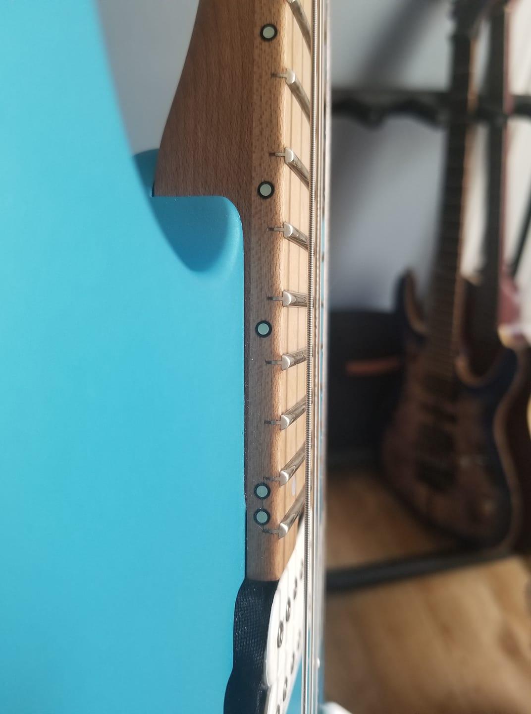 Should a guitar's neck be parallel to the body or at an incline/decline
