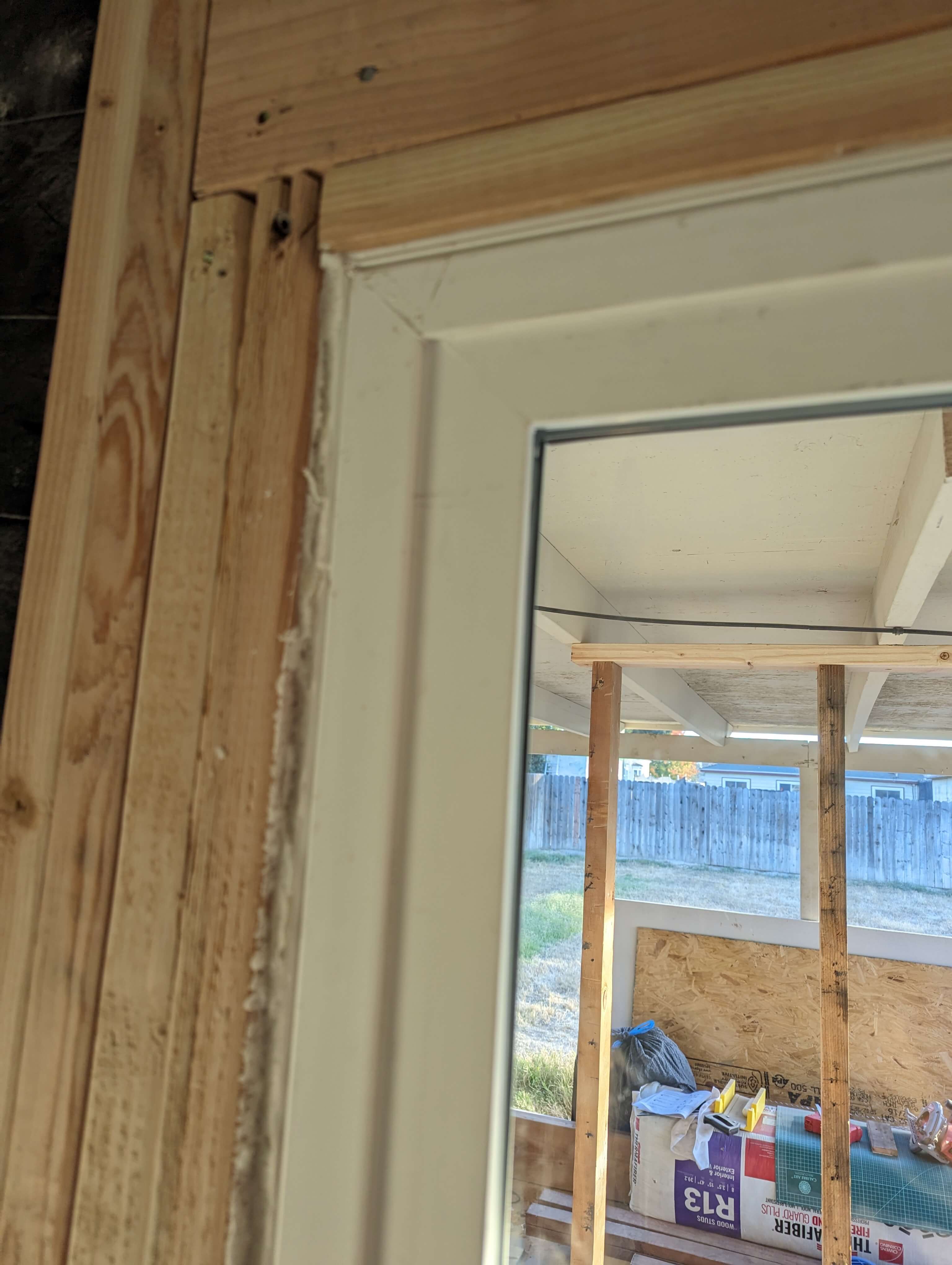 How can I install a new patio door where overhead framing obstructs