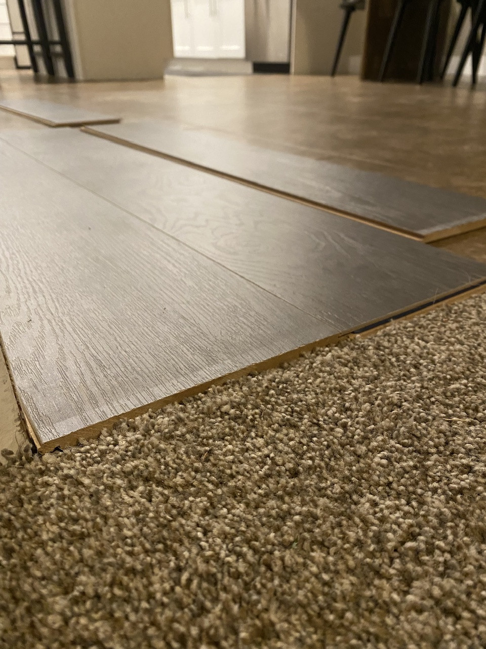 What is the best way to transition between plank flooring laid on top