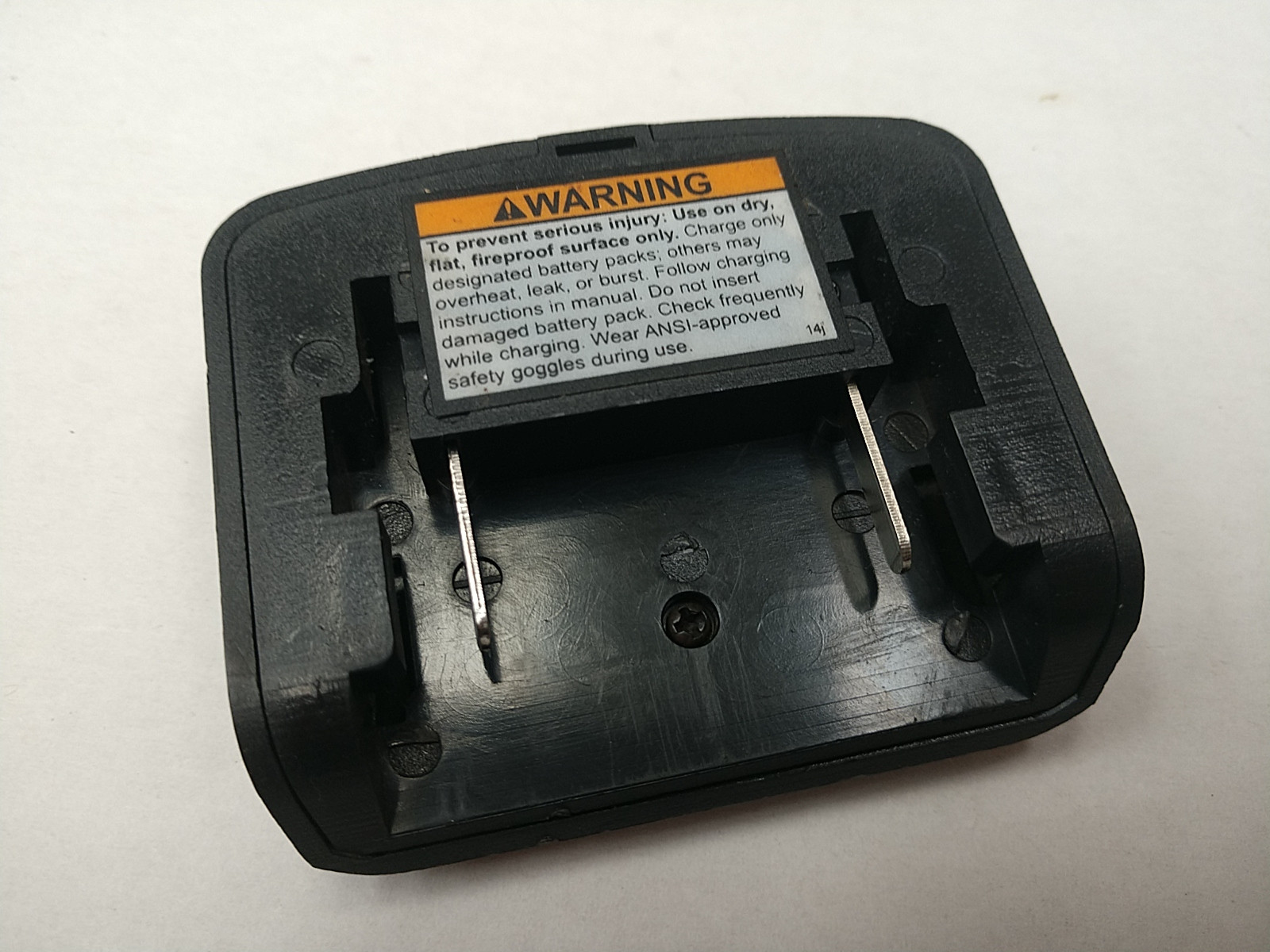 18V battery charger showing hazardous voltage symbol on Fluke