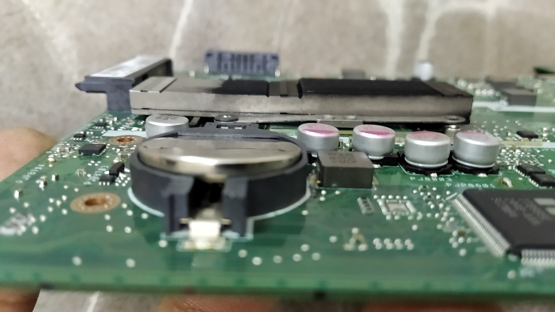 How to firmly place CMOS battery on Asus X200MA Laptop motherboard