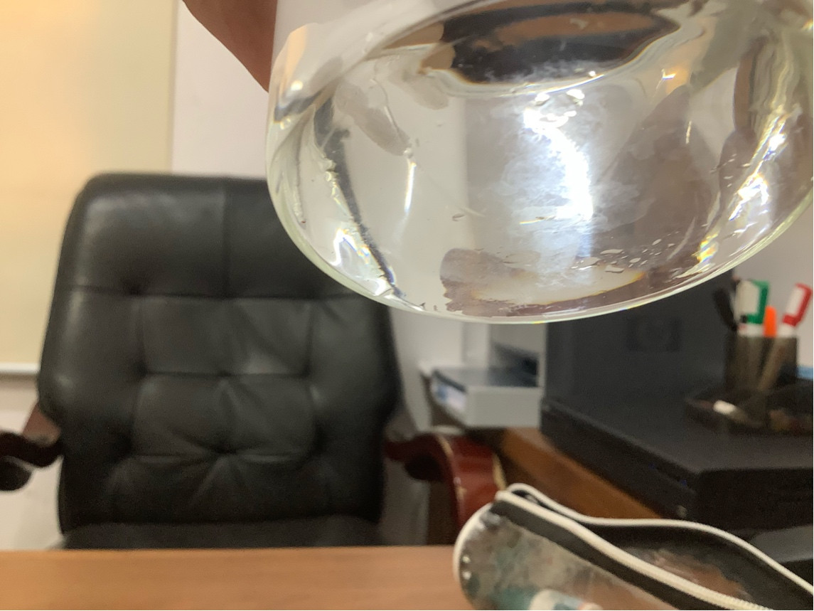 fluid mechanics Why does this glass tend to stick on surfaces