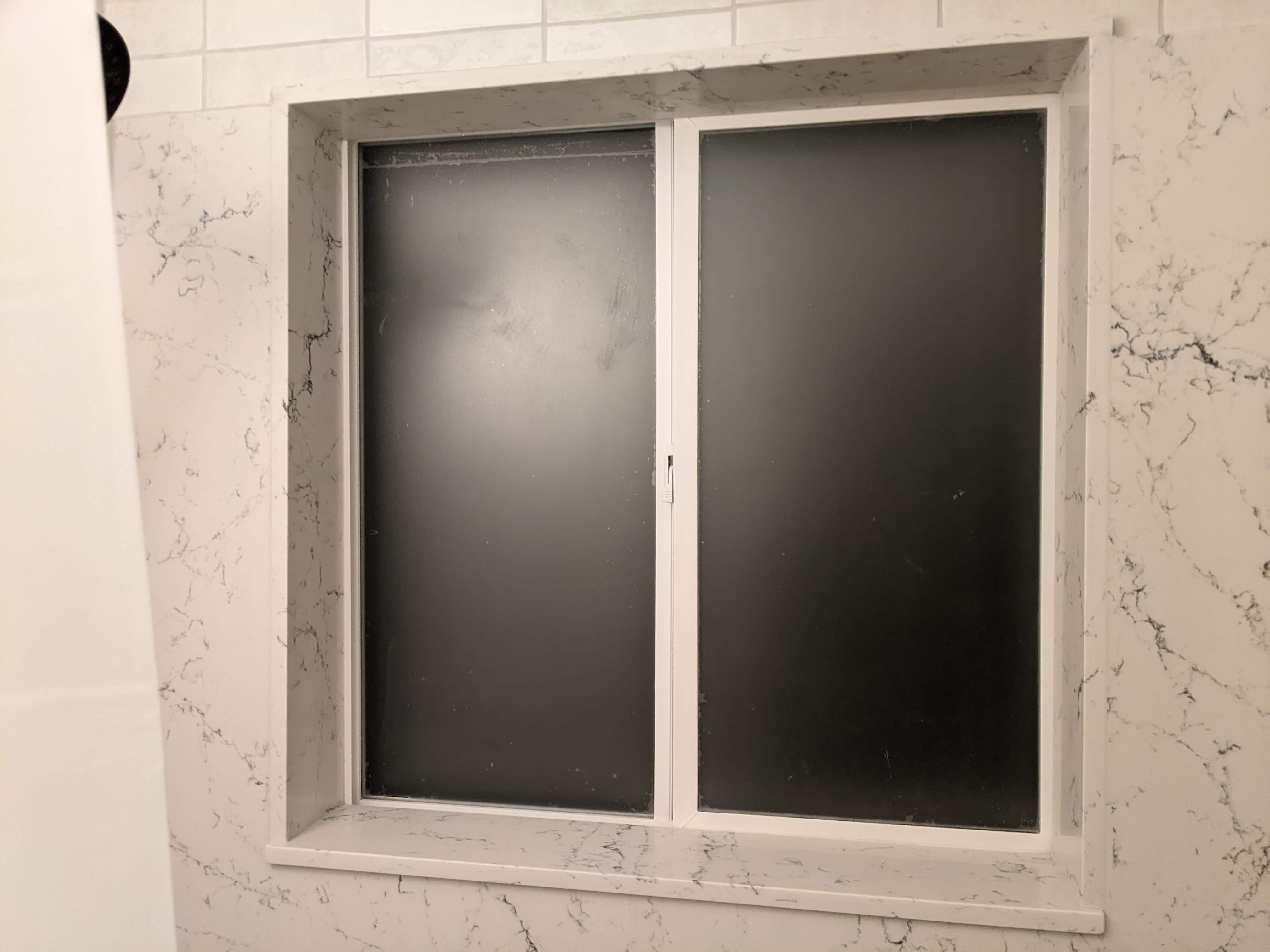 What type of window is acceptable for installation inside of a shower