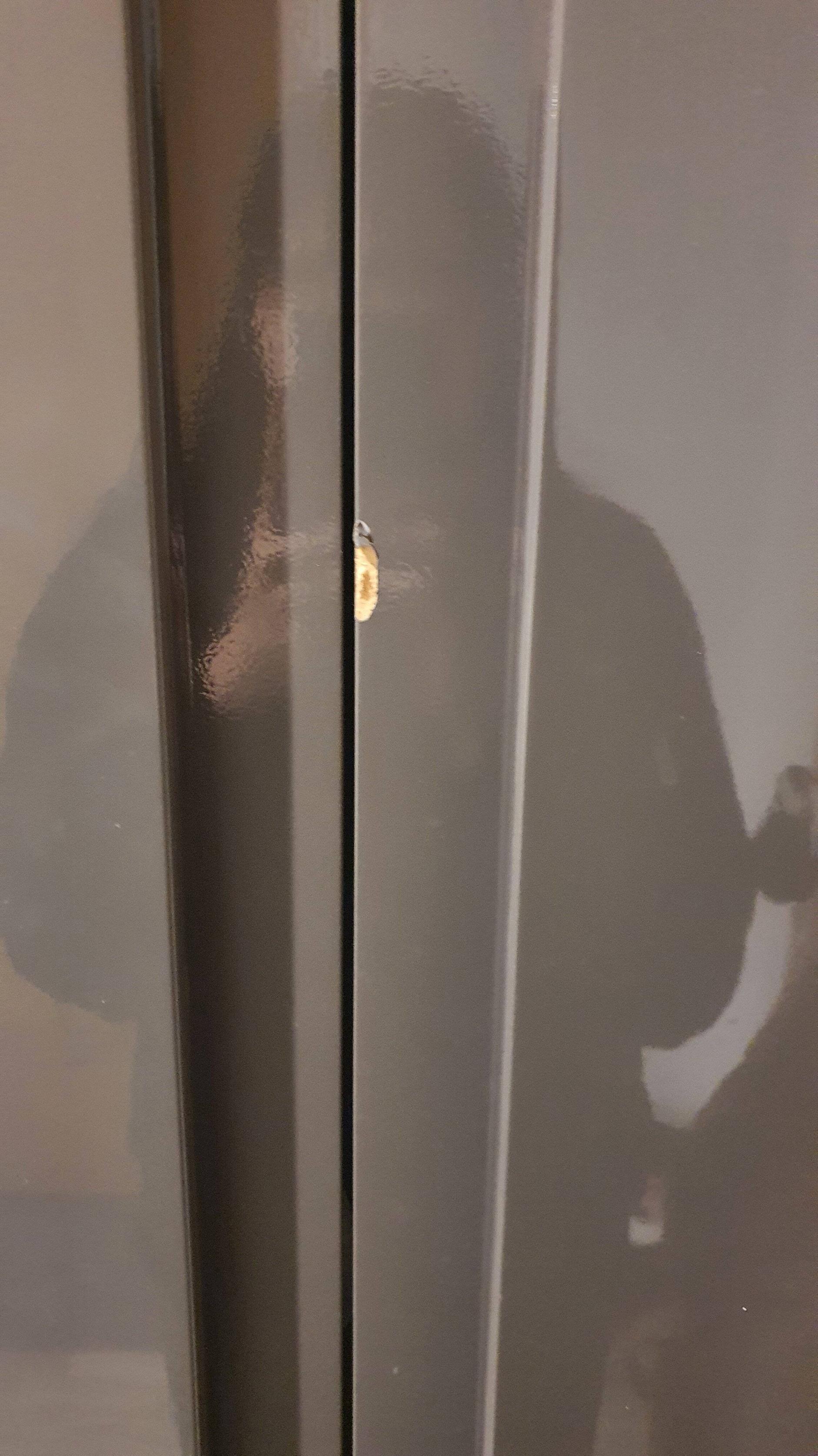 How to fix this dent/crack/chip at the edge of the door of laminated