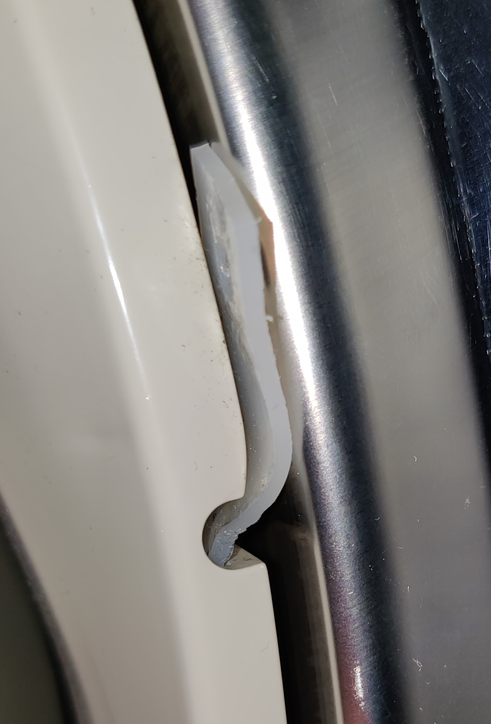 repair A plastic tab/tag stuck out of the GE dryer drum gap. Does