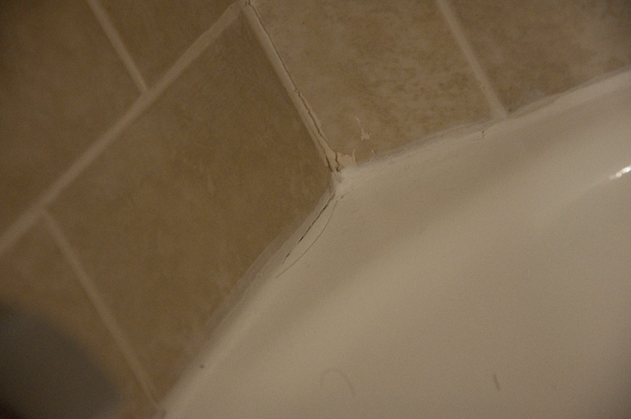 Plumbing Tub reglazed and recaulked, drippy residue from caulking