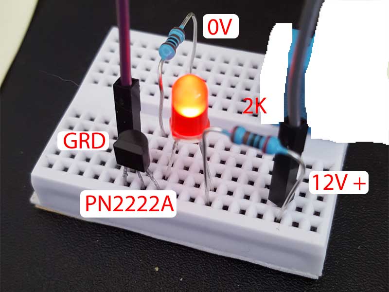 Why does this transistor circuit light the LED? Electrical