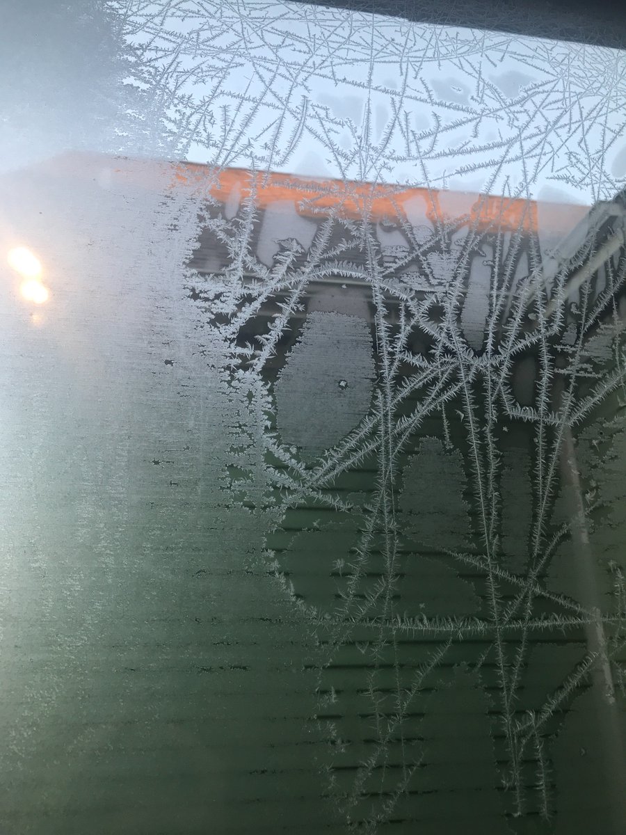 thermodynamics Why does ice freeze in feathery streaks on windows