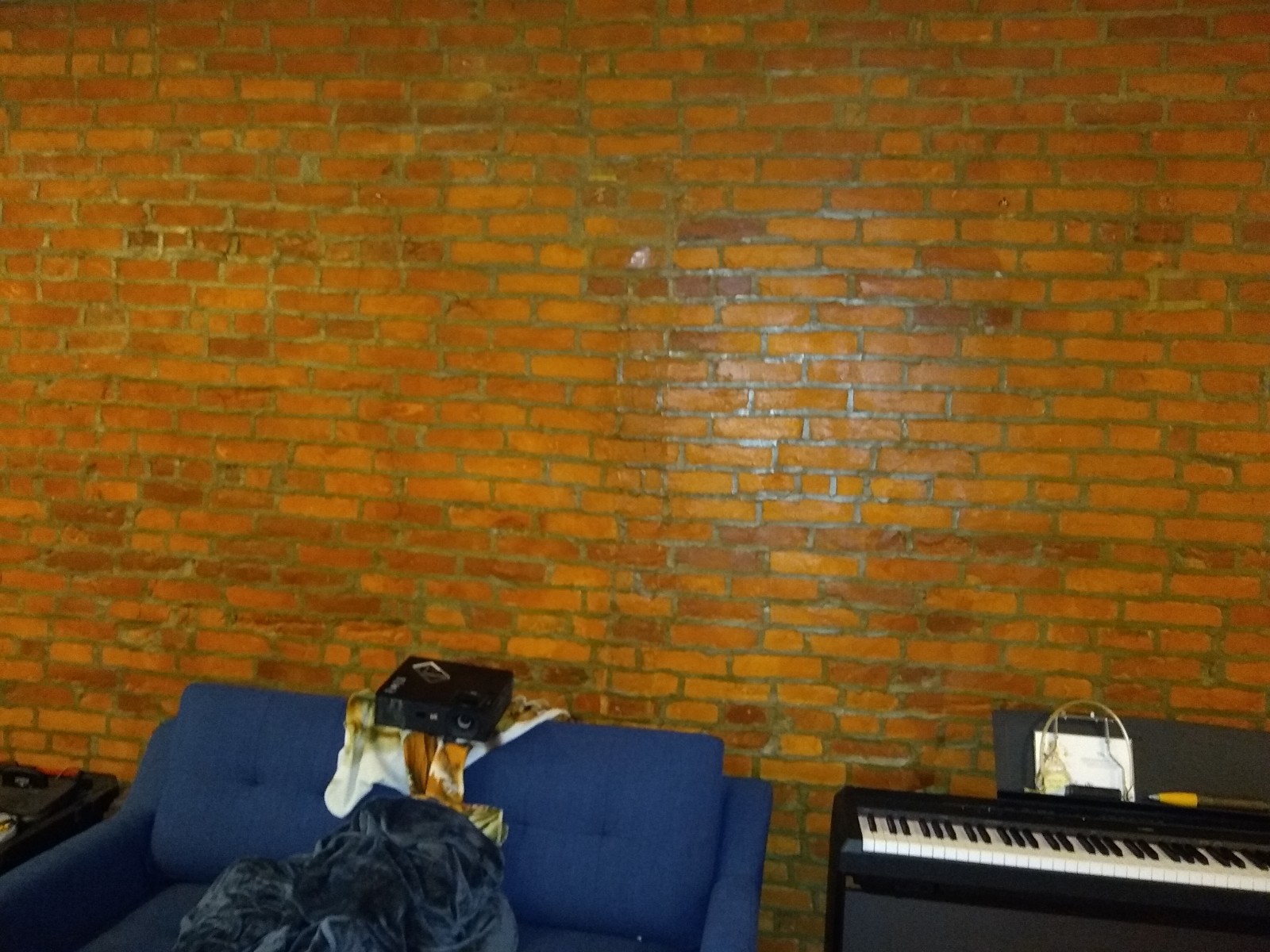 How can I hang a shelf off of existing screws in brick