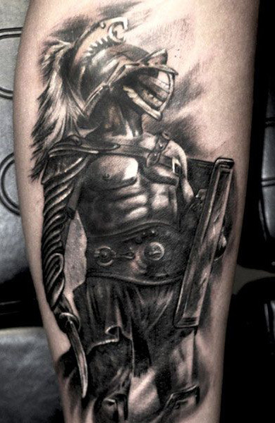 What Does The Gladiator Tattoo Mean? Male Gladiator Tattoo And His Attributes - Helmet, Armor, Shoulder Pad Gladiator Tattoo On The Calf. 600_x_390_jpg