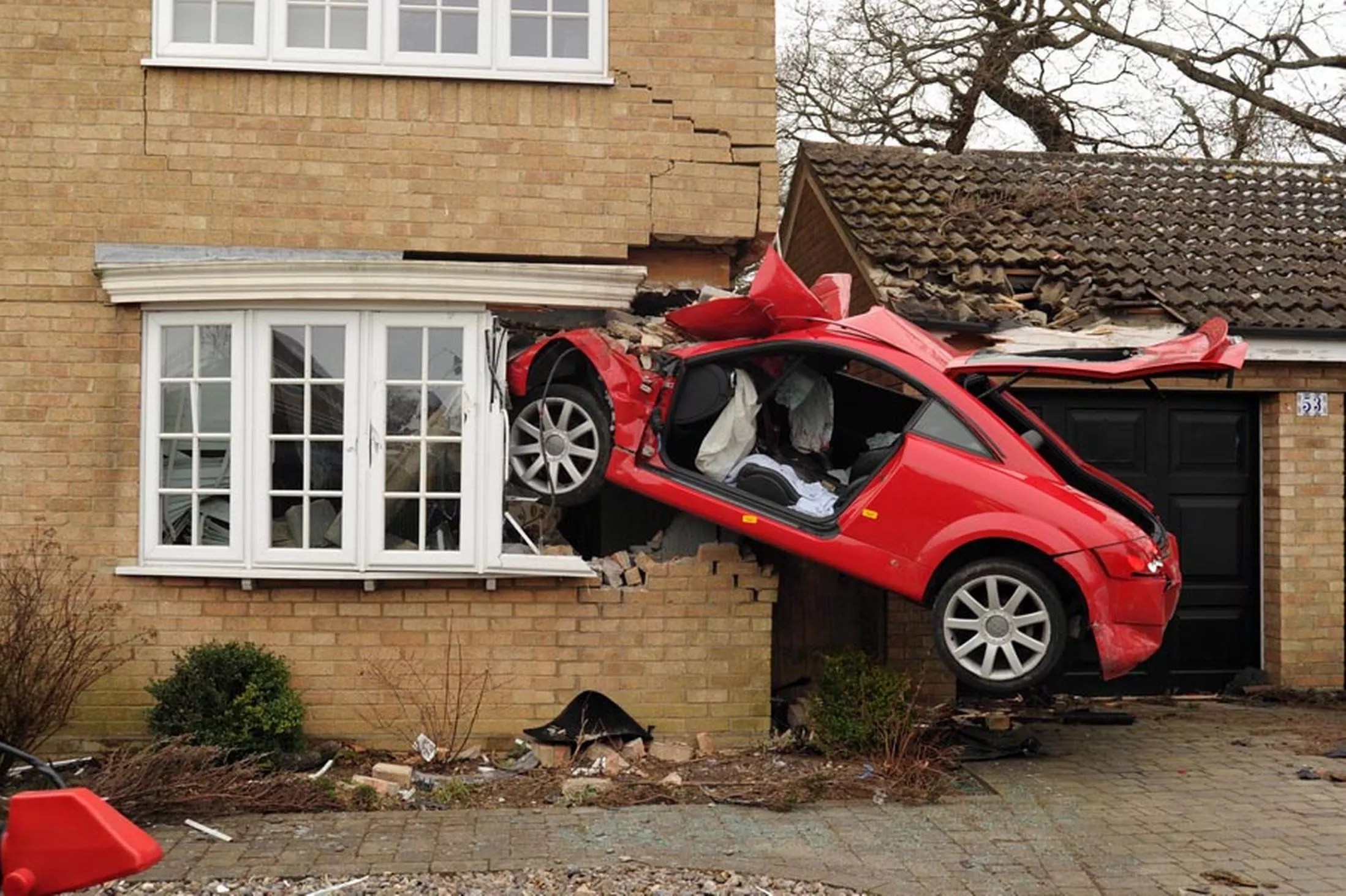 Audi driver left fighting for life after airborne crash into house to