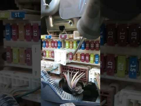 At which point is the fuse box located in the engine compartment of the