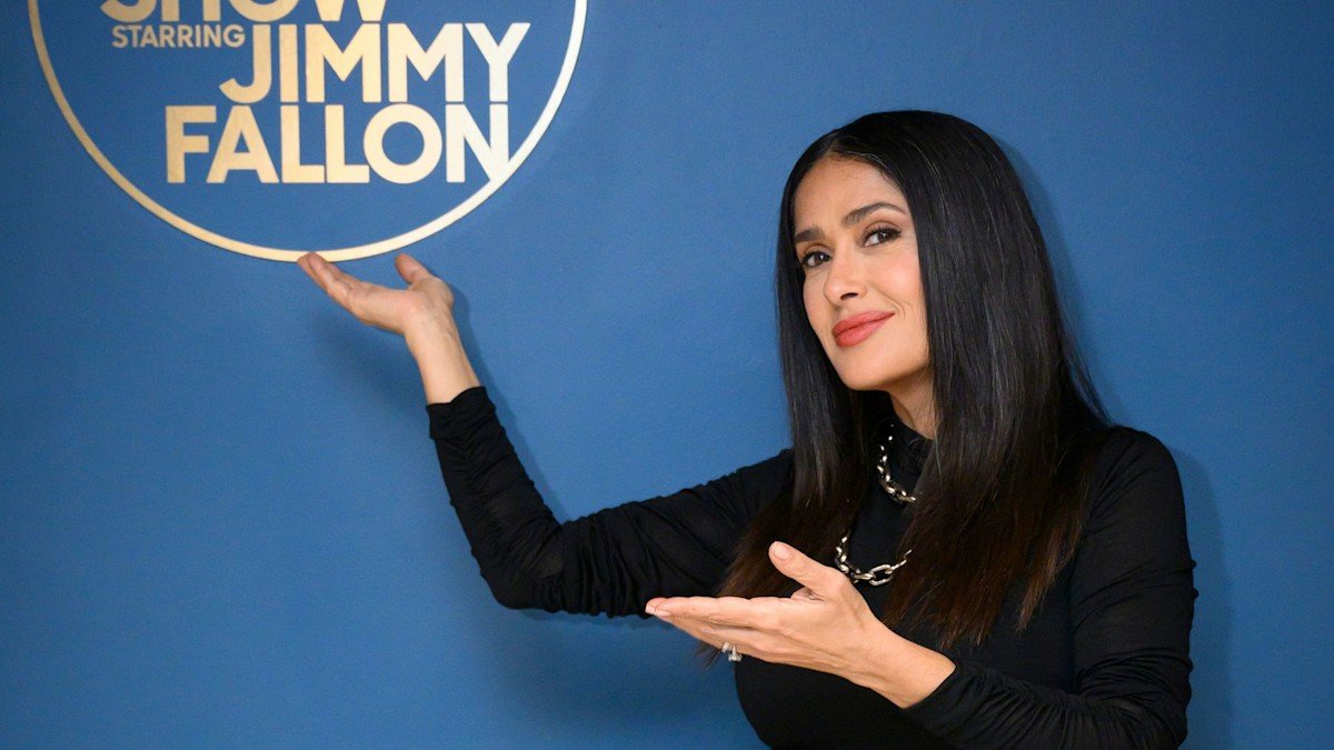 Salma Hayek rocks black mini dress and thigh high boots in latest